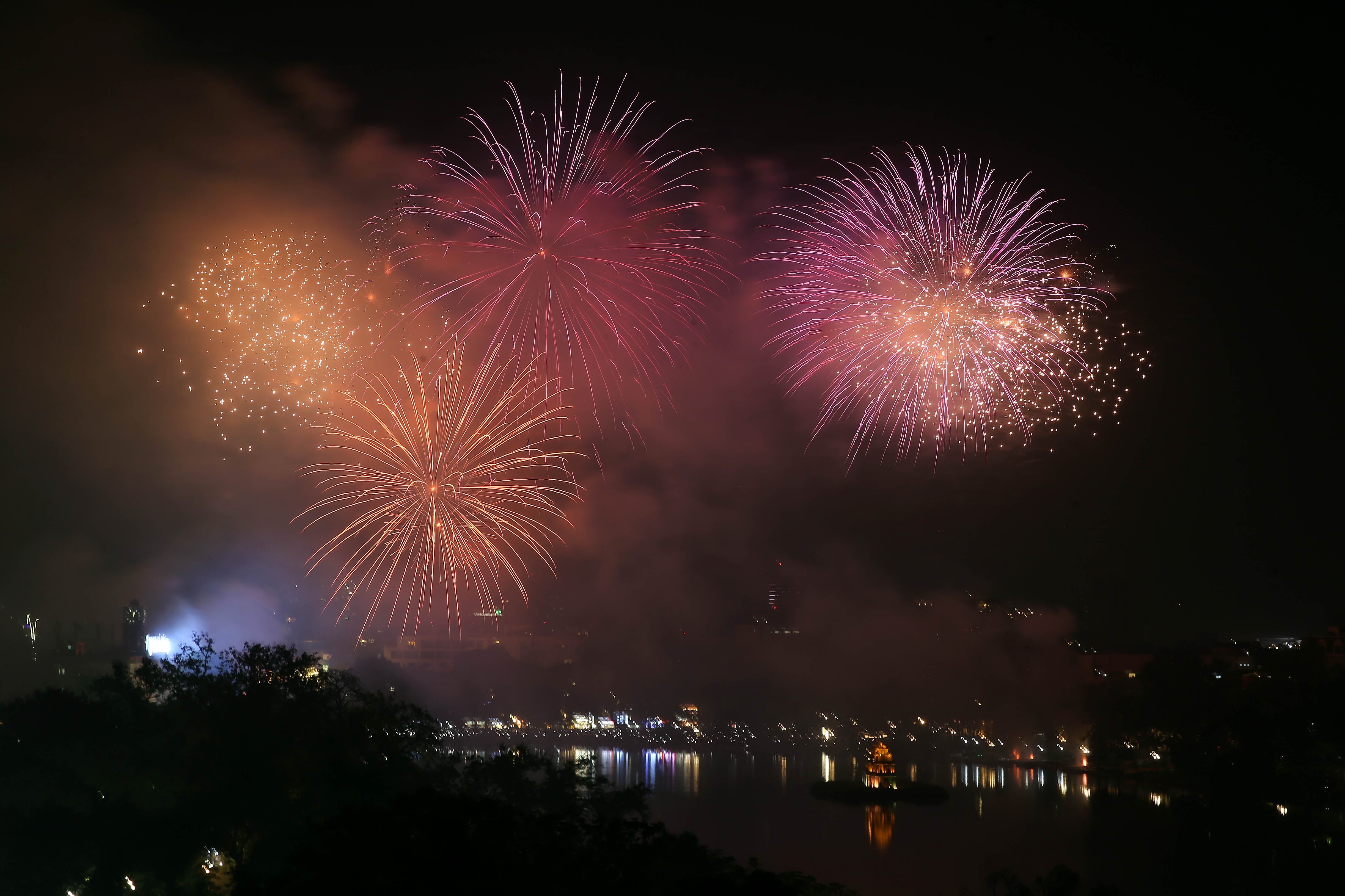 Fireworks illuminate the sky over Hoan Kiem Lake in Hanoi