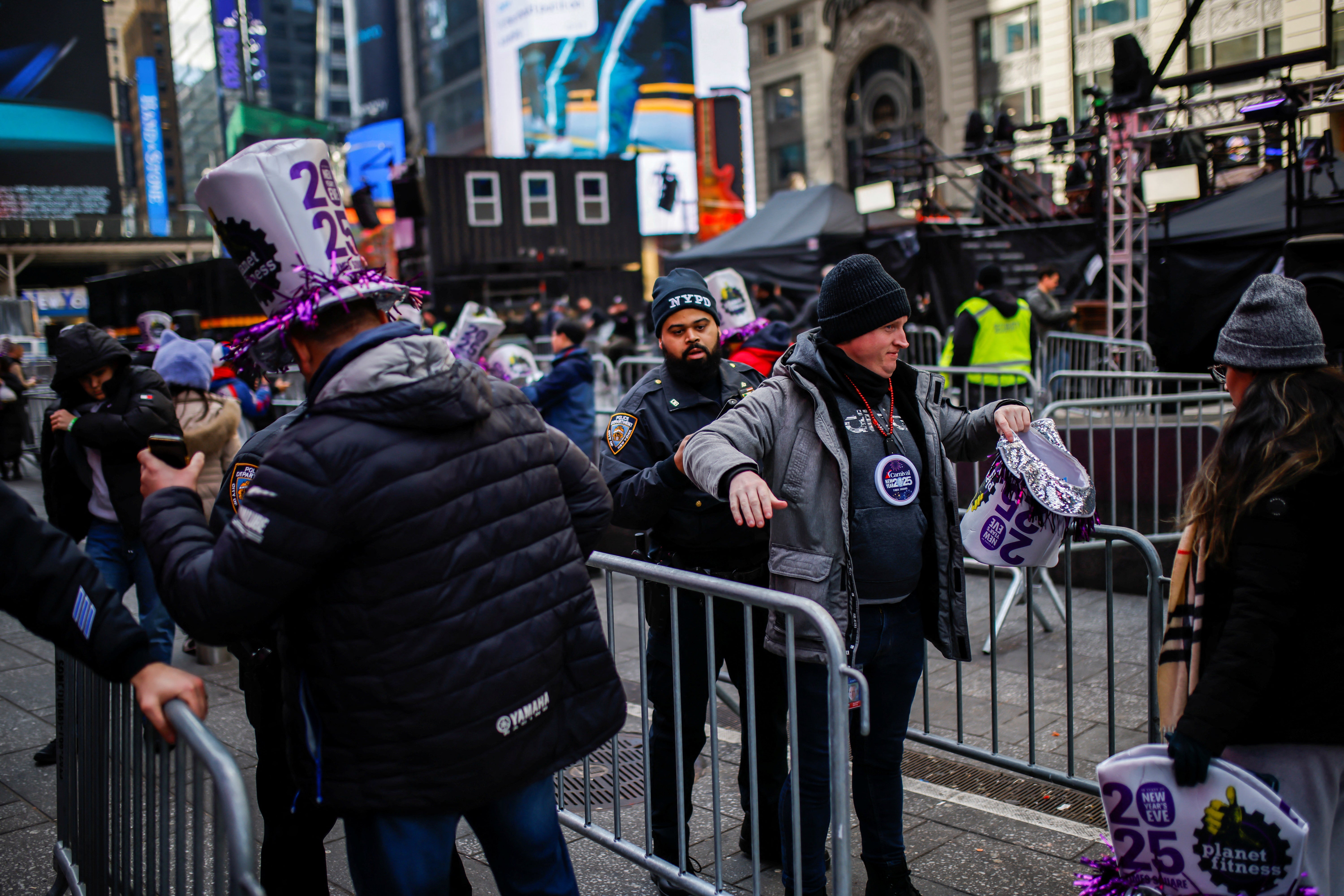 Officers from the New York City Police Department (NYPD) operate at a check point as people arrive to Times Square in New York for New Year’s Eve