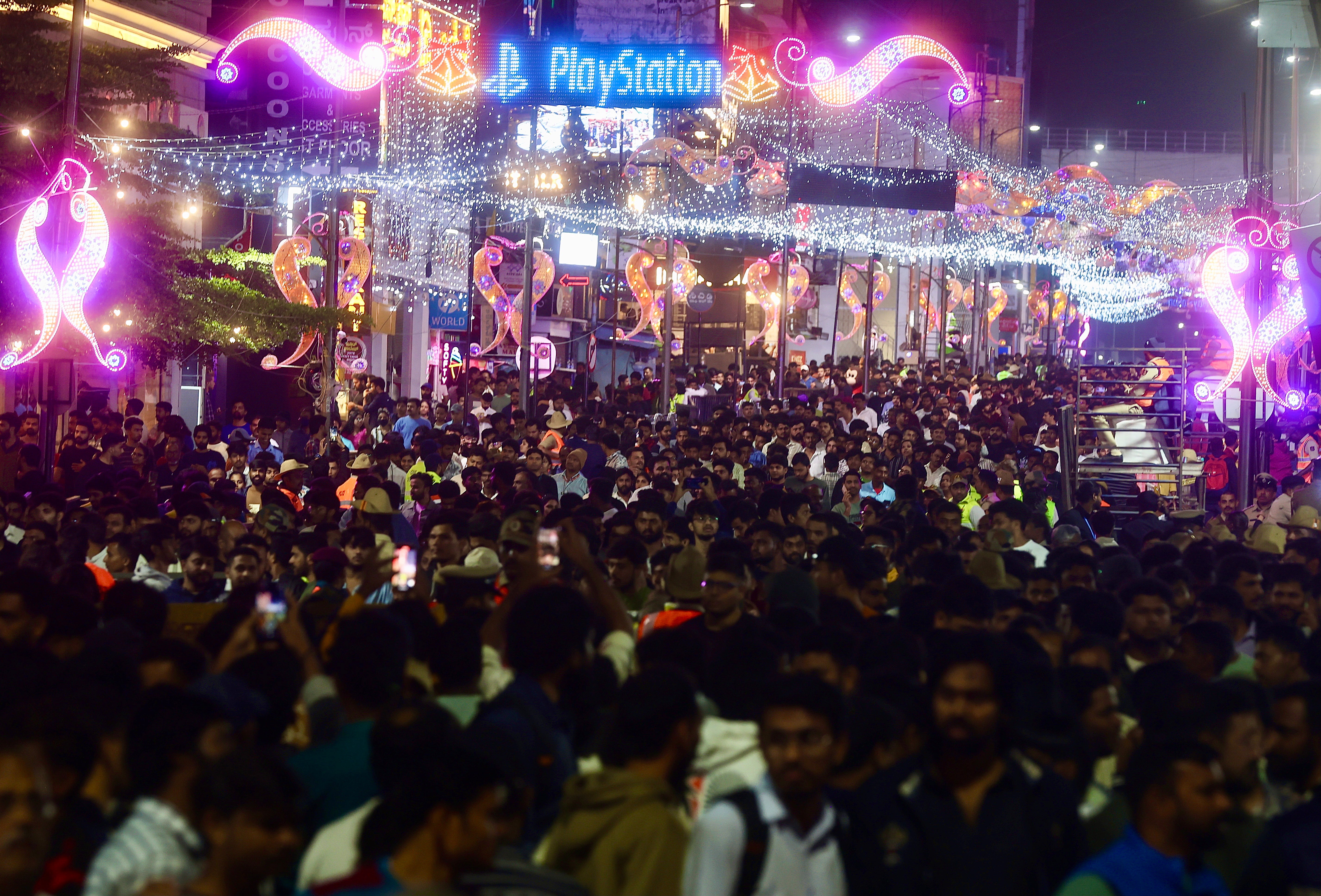 A crowd lines the street in Bangalore as the city enters 2025