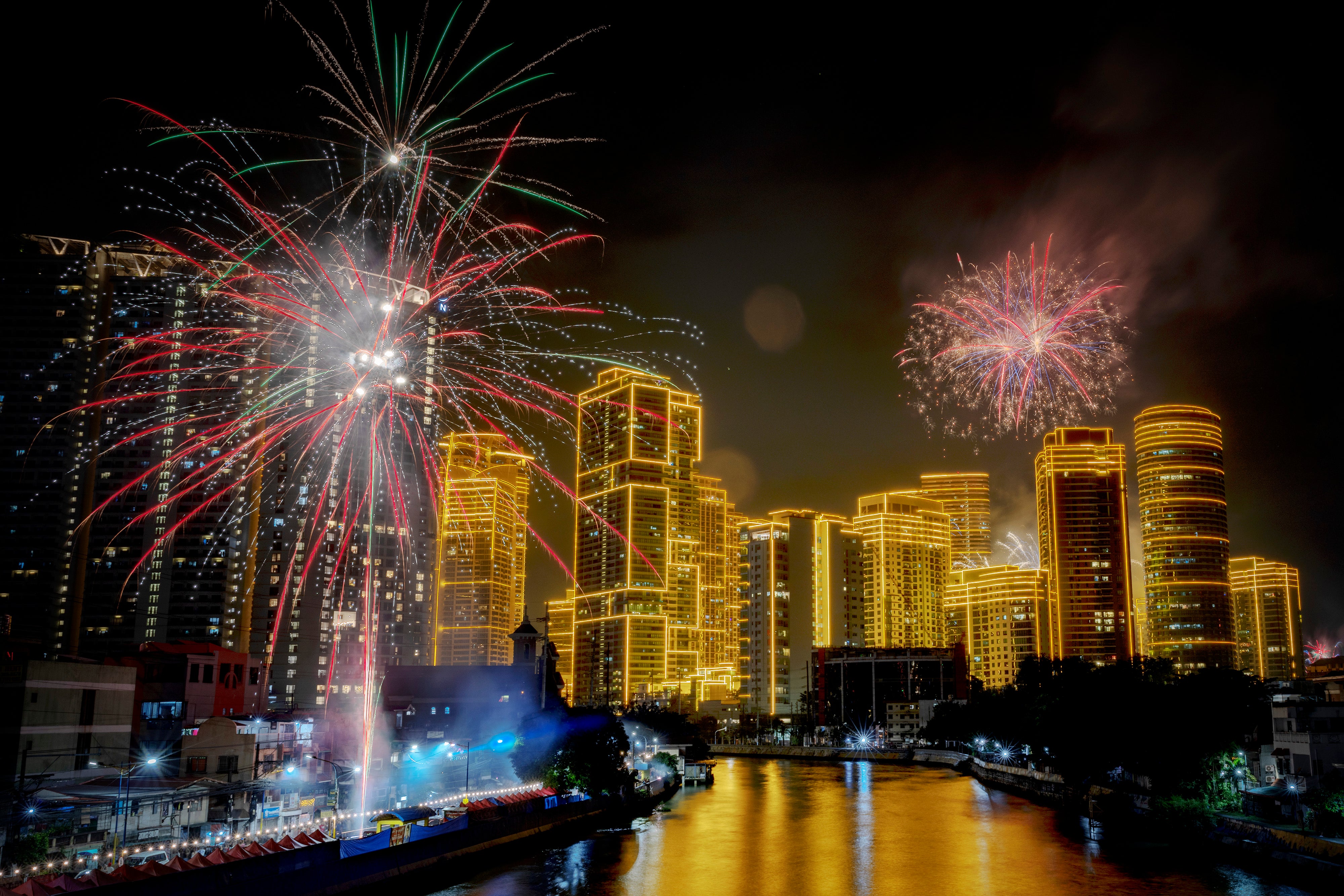 Fireworks explode over the Rockwell Center in Manila