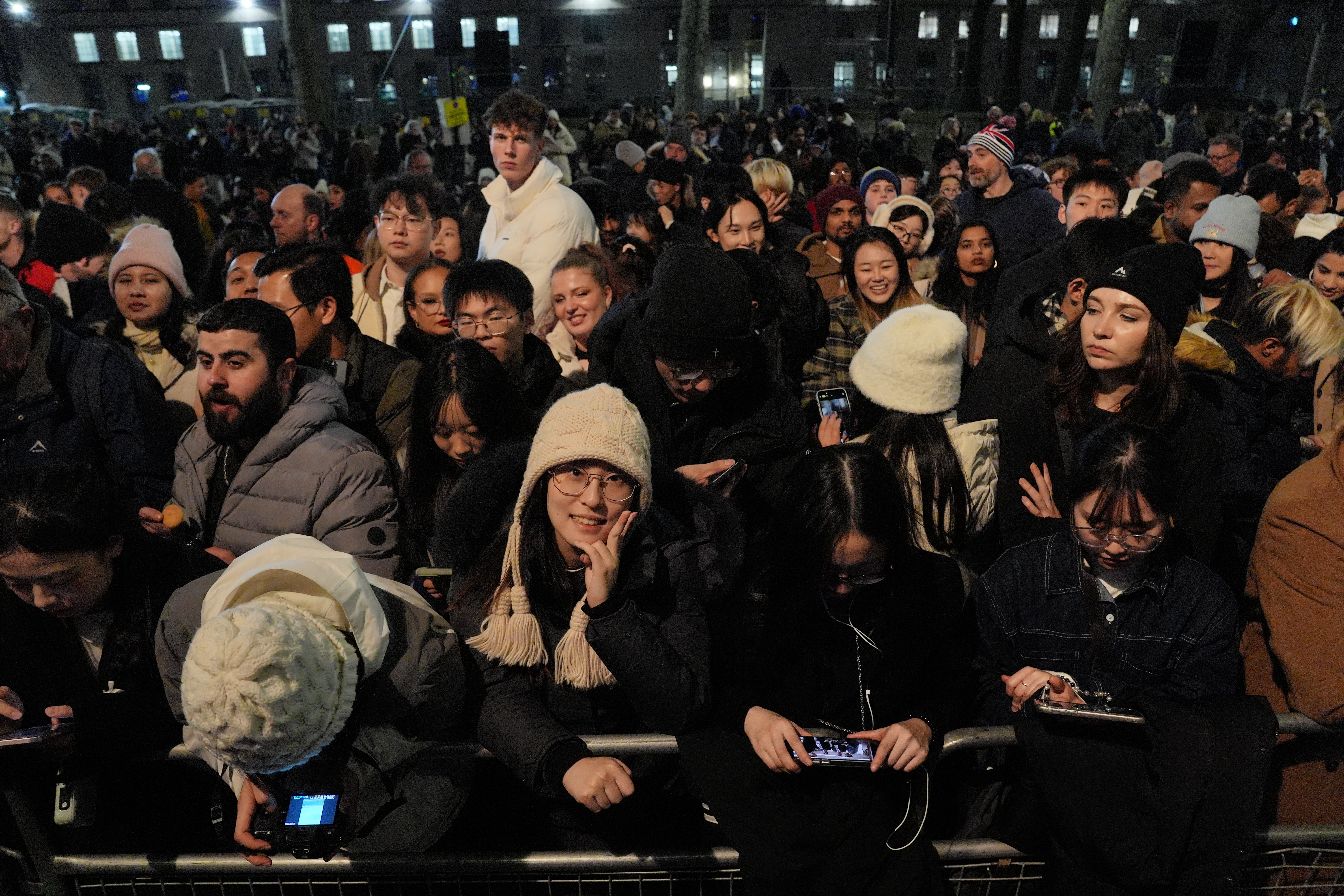 People on London's Embankment waiting for the start of the fireworks display to see in the New Year