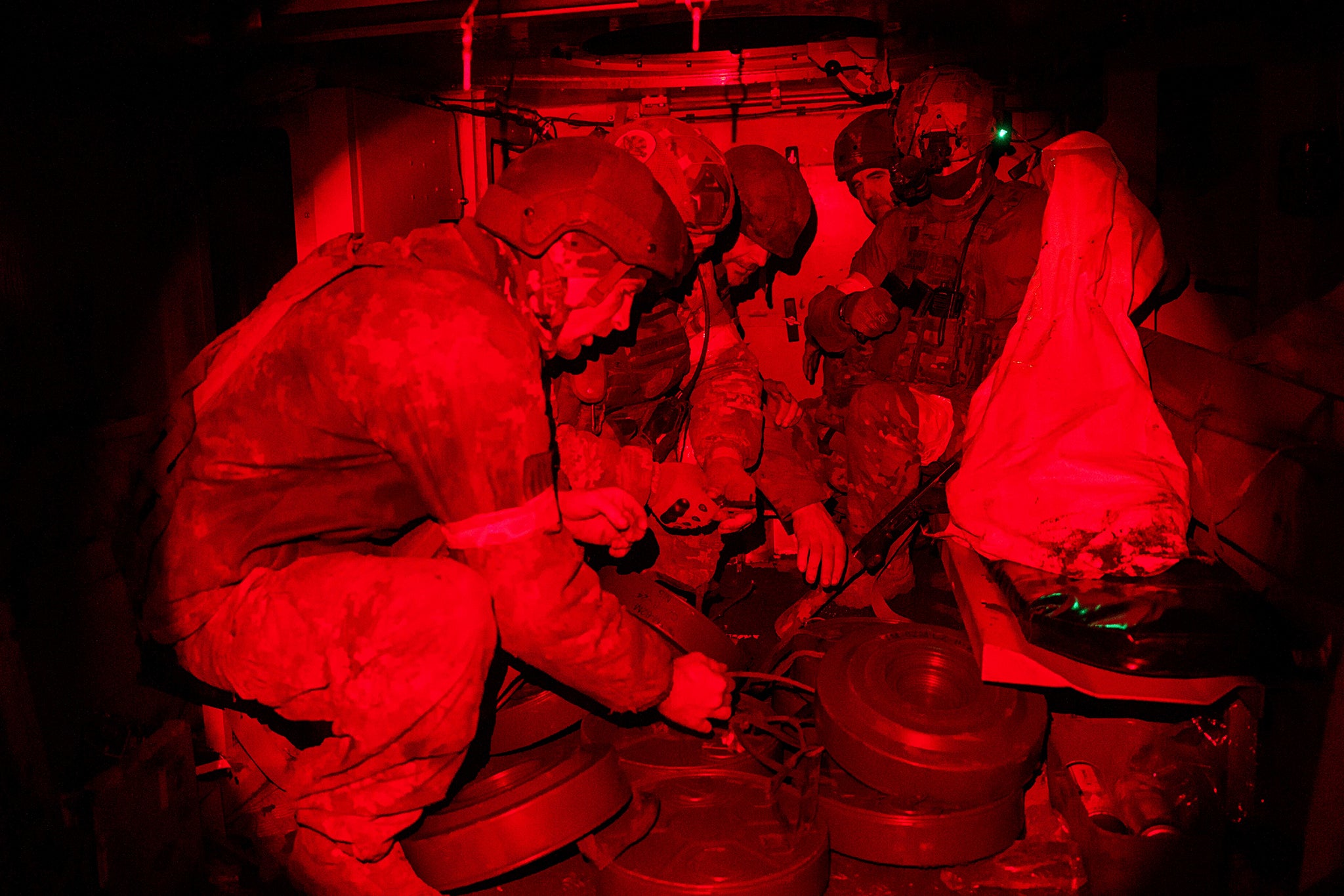 Ukrainian soldiers of Skala Battalion load anti-tank mines into an armoured vehicle near Pokrovsk