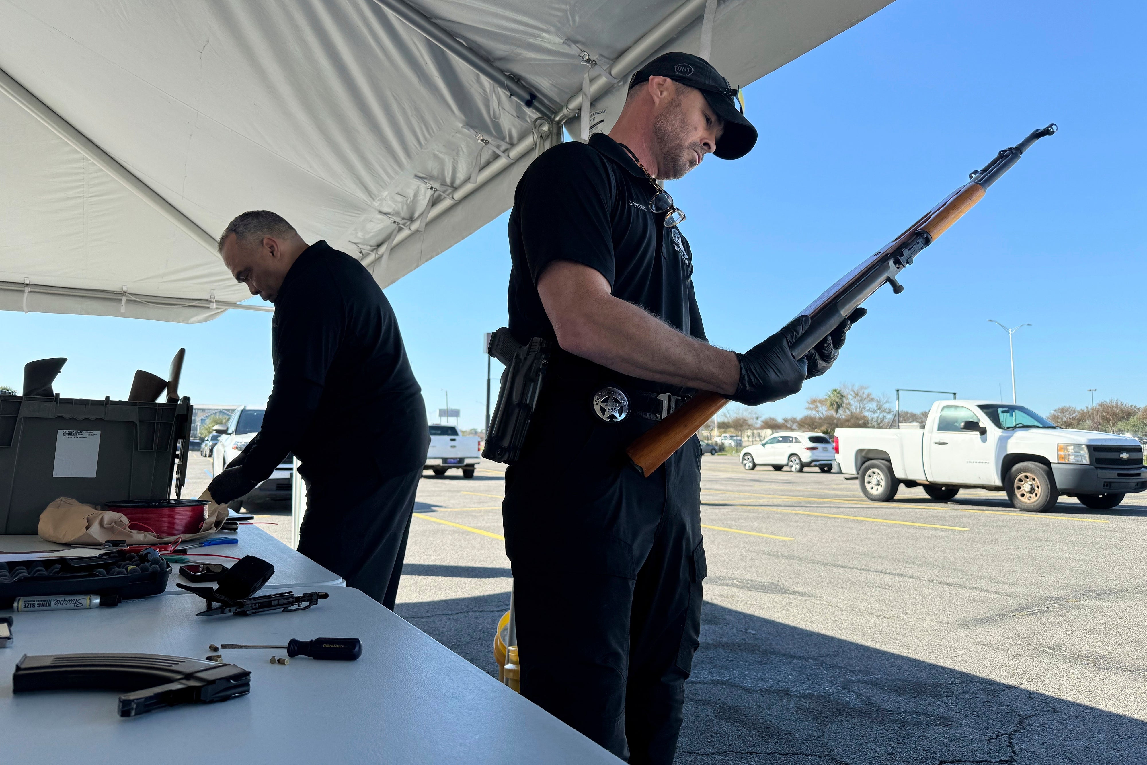 Gun Trade-in New Orleans police officer John Mciver dismantles a firearm handed over Orleans