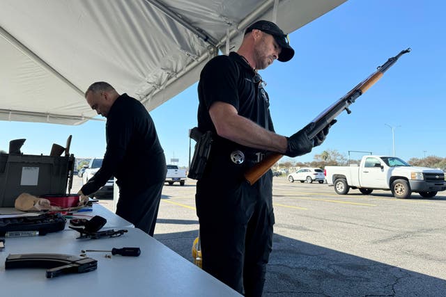 <p>Gun Trade-in New Orleans police officer John Mciver dismantles a firearm handed over Orleans</p>