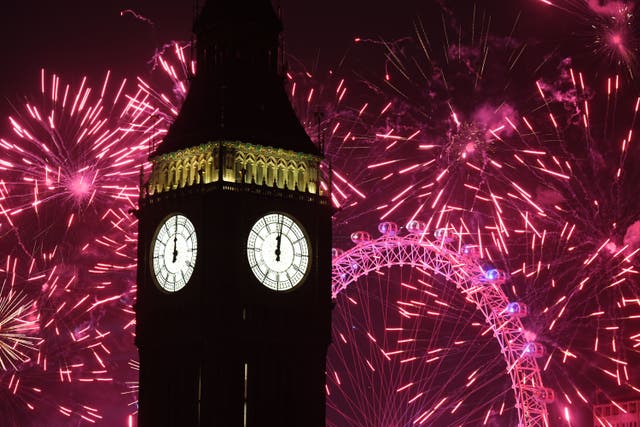 Fireworks light up the sky over Elizabeth Tower, also known as Big Ben, and the London Eye in central London during the New Year celebrations (James Manning/PA)