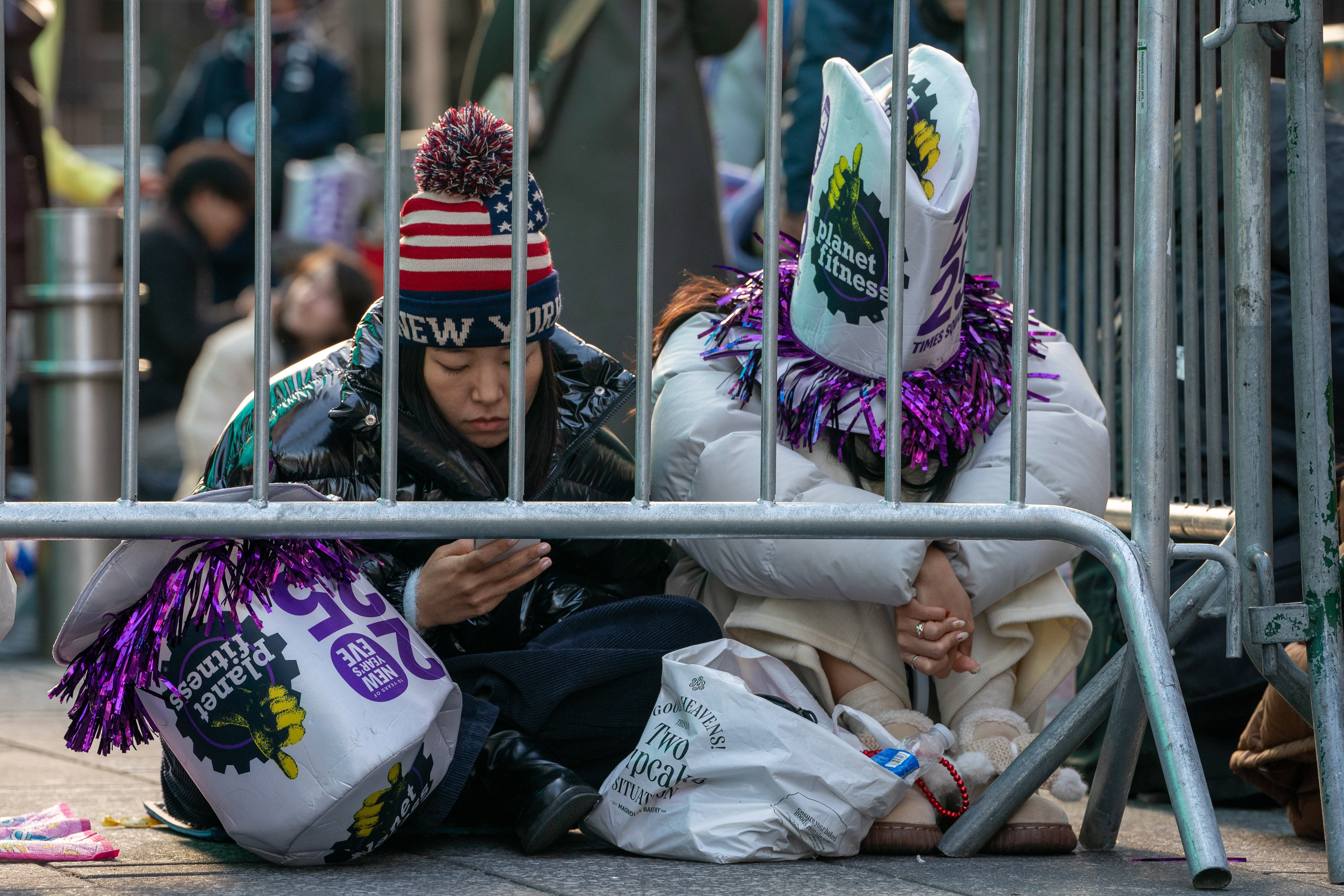 Revelers sit in Times Square prior to the New Year's Eve celebrations in Manhattan.