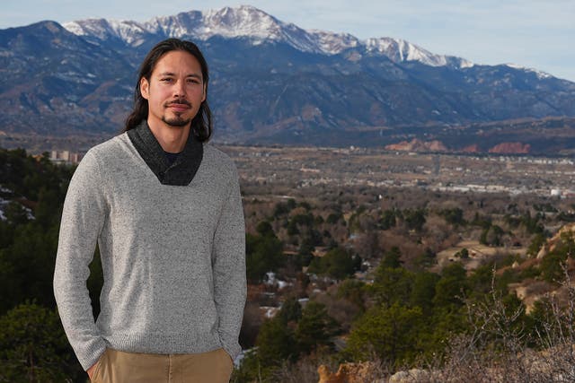 <p>Lane Belone poses with Pikes Peak in the background on an overlook in Palmer Park, Thursday, Dec. 19, 2024, in Colorado Springs, Colorado </p>