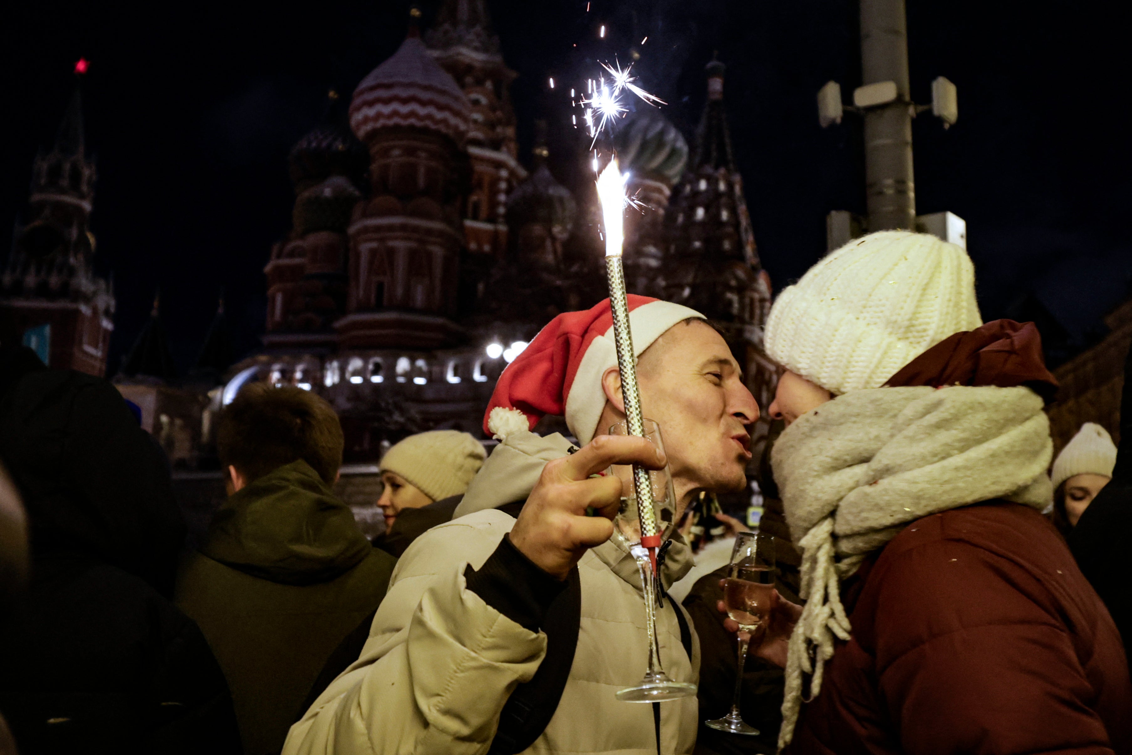 People celebrate the New Year outside the Kremlin in central Moscow