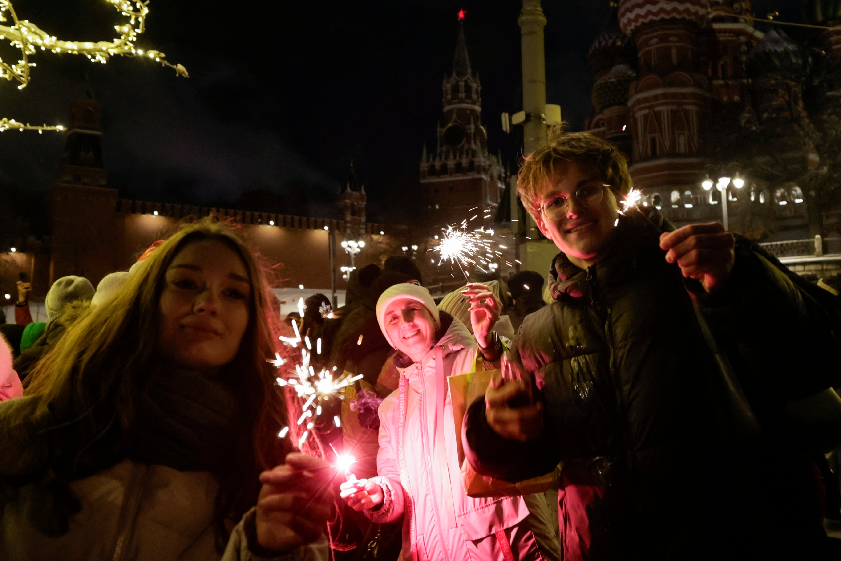 People celebrate the New Year outside the Kremlin in central Moscow