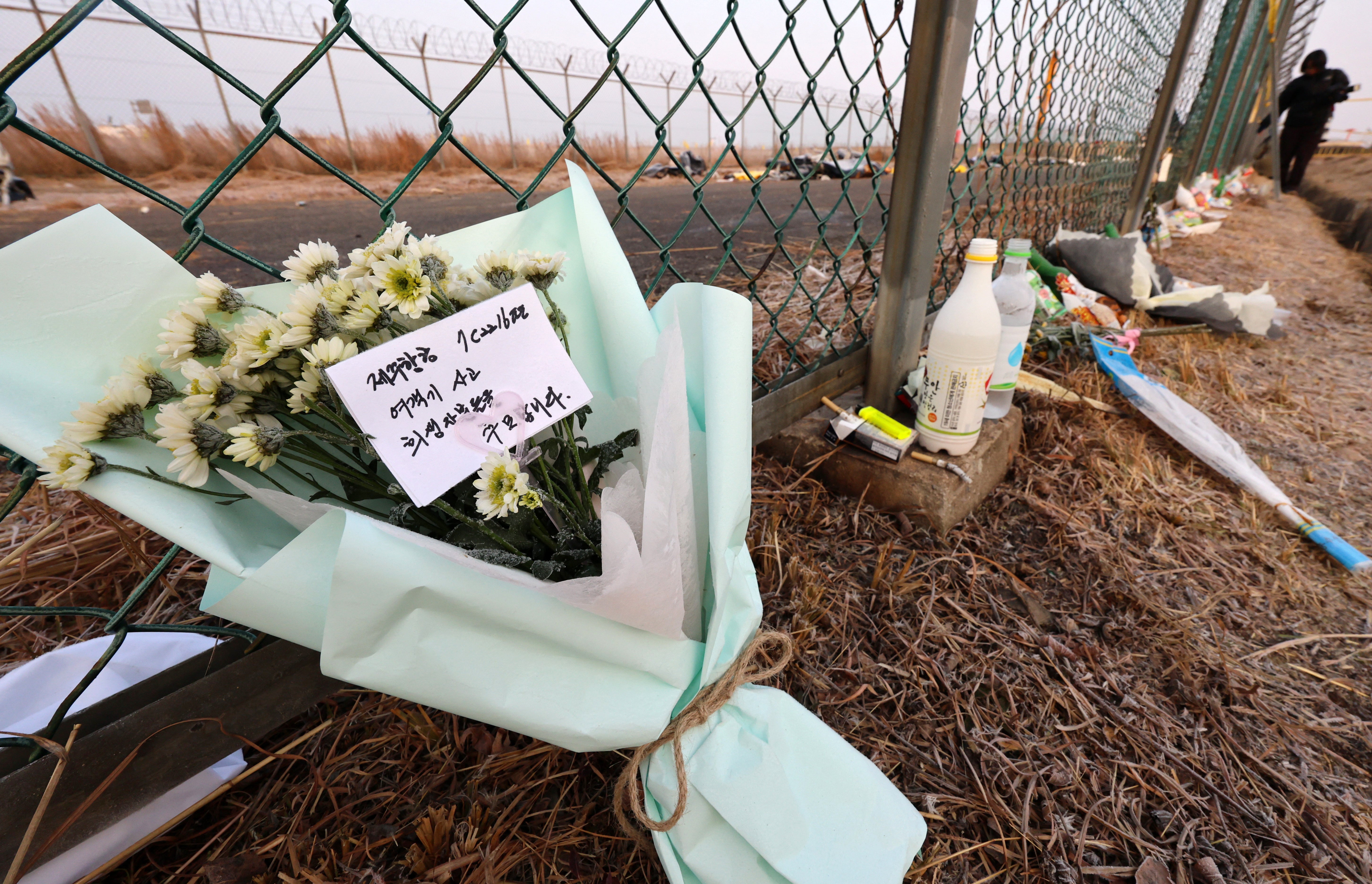 Tributes are placed along a fence near the site of the Jeju Air Boeing 737-800 plane crash