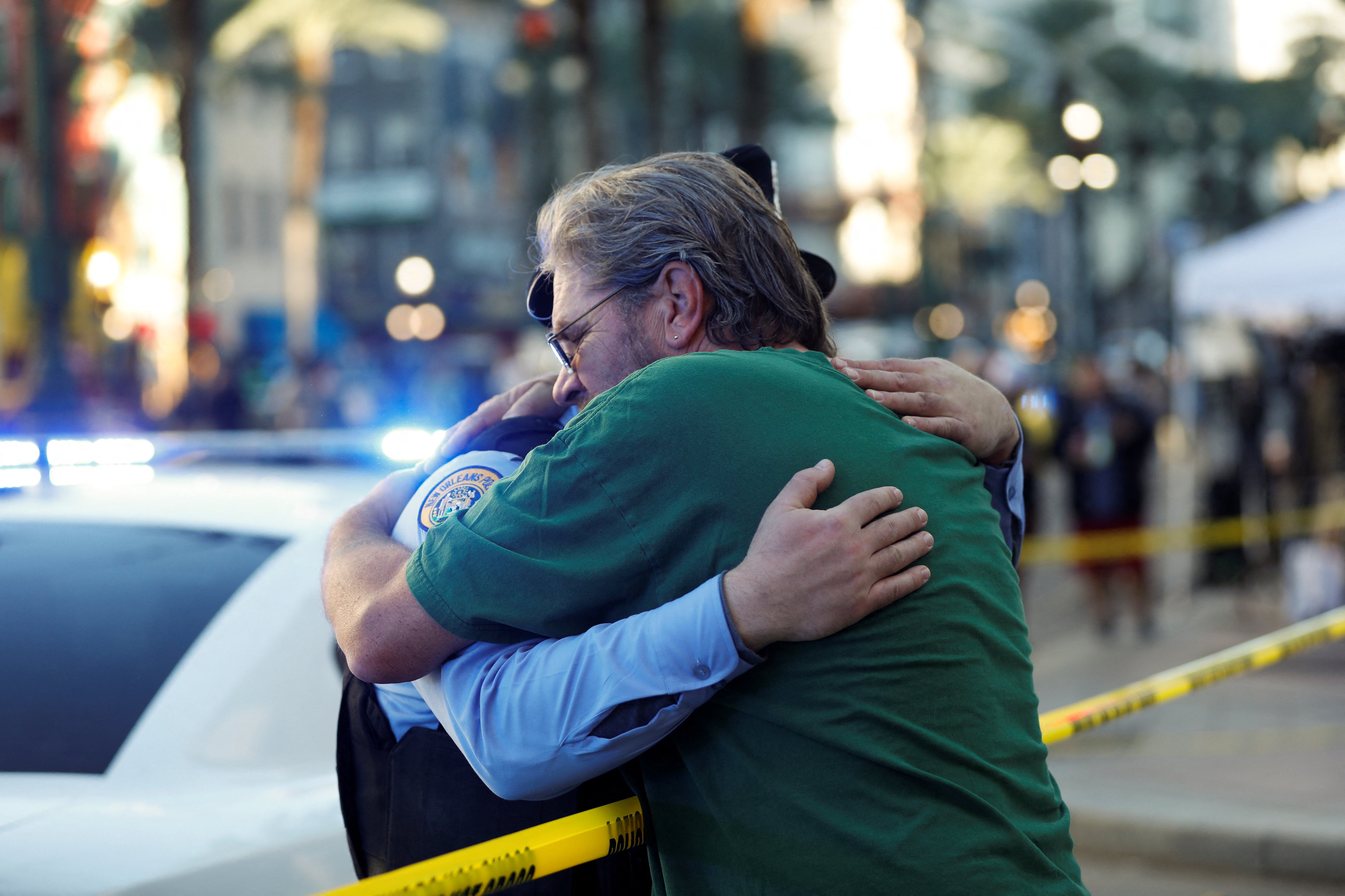 Edward Bruski hugs New Orleans Police Officer Zachary Stevenson on Canal street, near the French Quarter