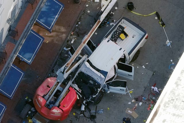 <p>A black flag with white lettering lies on the ground rolled up behind a pickup truck that a man drove into a crowd on Bourbon Street in New Orleans, killing and injuring a number of people, early Wednesday morning, Jan. 1, 2025</p>