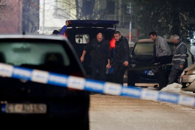 <p>Workers at the scene after a gunman opened fire and killed several people in a restaurant in Cetinje, Montenegro</p>