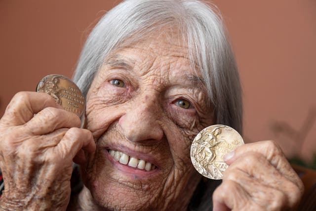 <p>Hungarian-Israeli Olympic and world champion artistic gymnast Agnes Keleti shows gold medals won at Helsinki 1952 and Melbourne 1956</p>