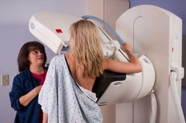 <p>A nurse helping a female patient during a digital mammogram</p>