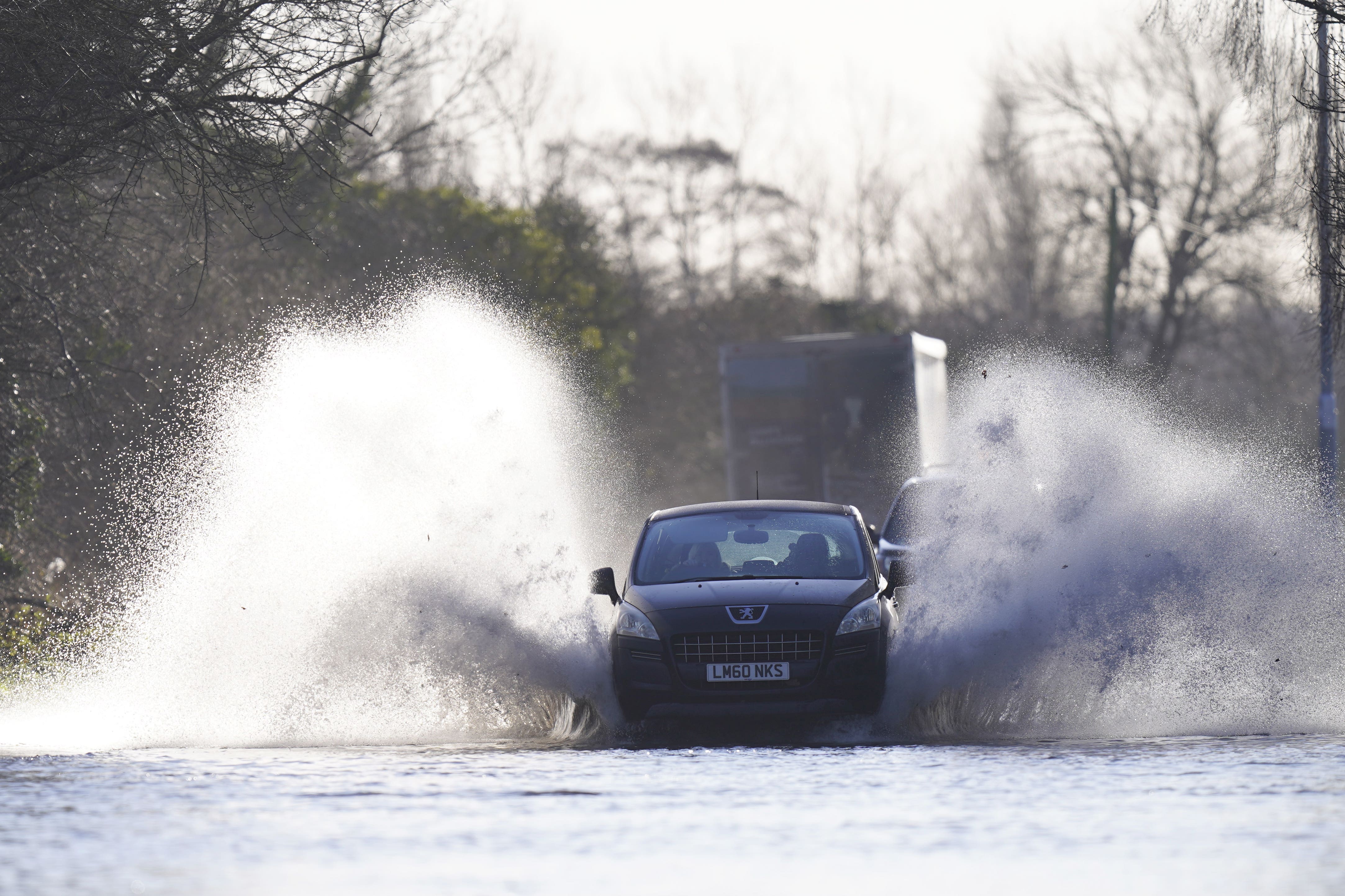 A vehicle drives through flood water in Allerton Bywater near Leeds (Danny Lawson/PA)