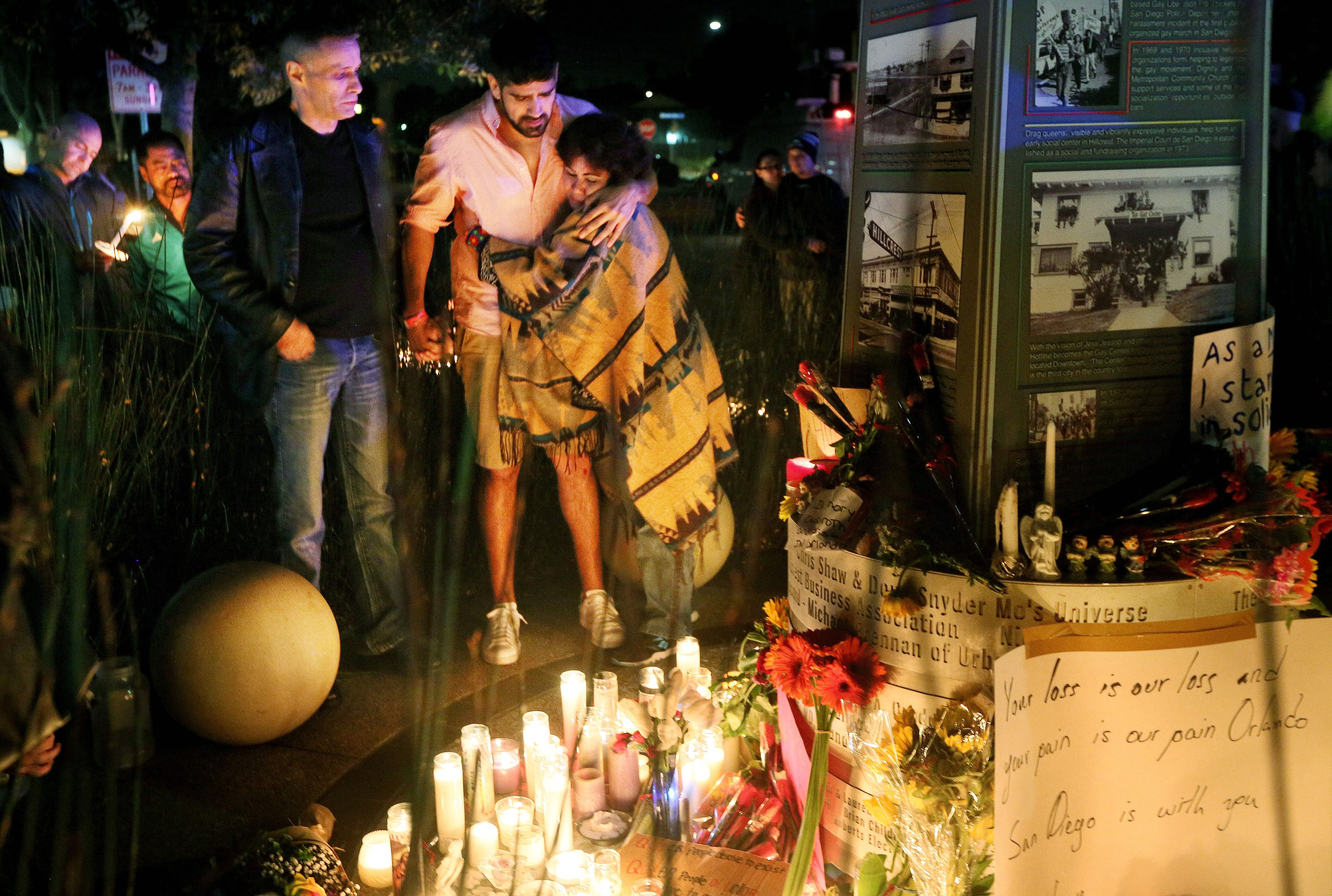 Mourners pay tribute to the victims of the Orlando shooting during a memorial service in San Diego, California on June 12, 2016.