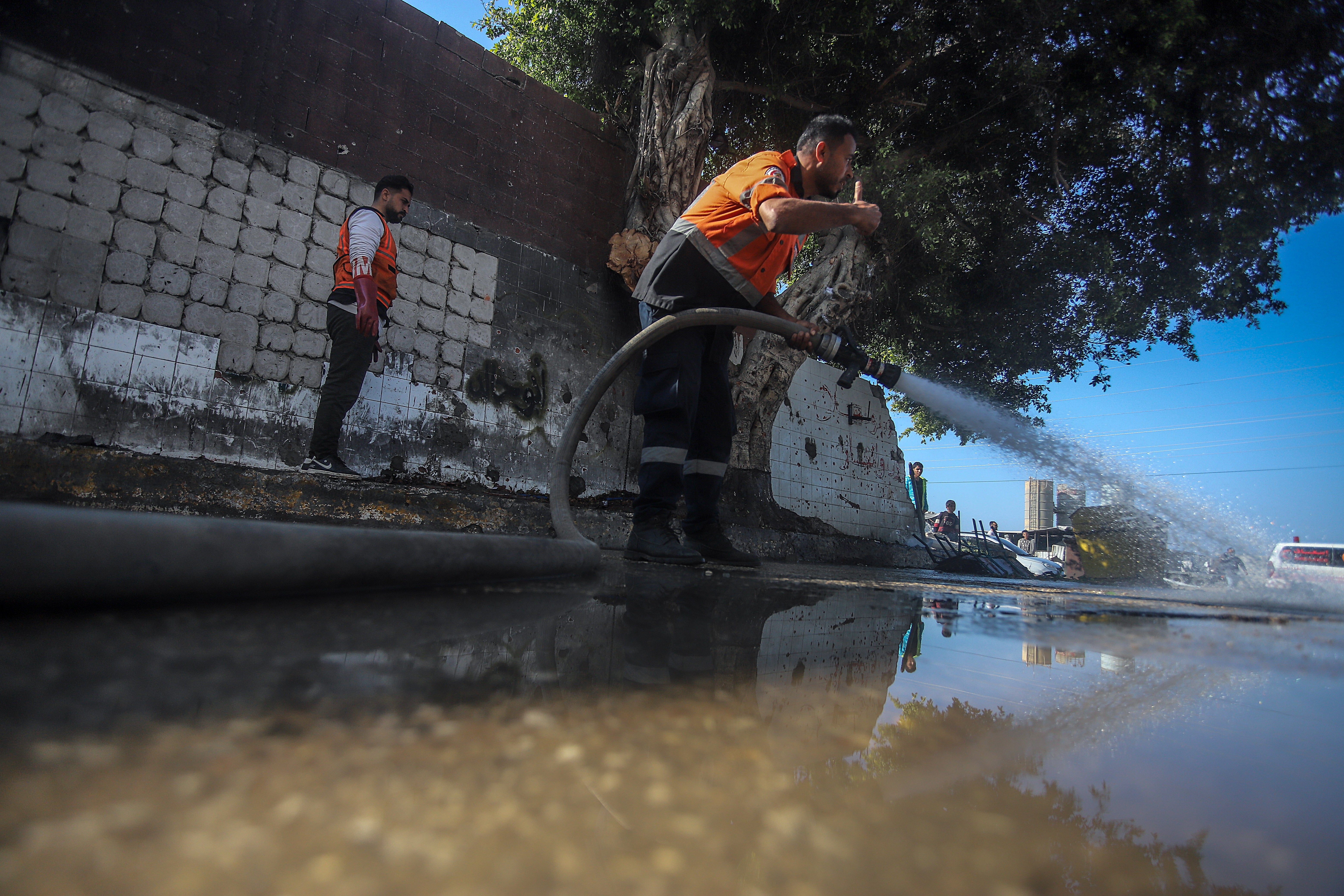 A member of the Palestinian civil defense works near a site following an Israeli airstrike on Salah Al Din Road near the Al Maghazi refugee camp on 2 January 2025