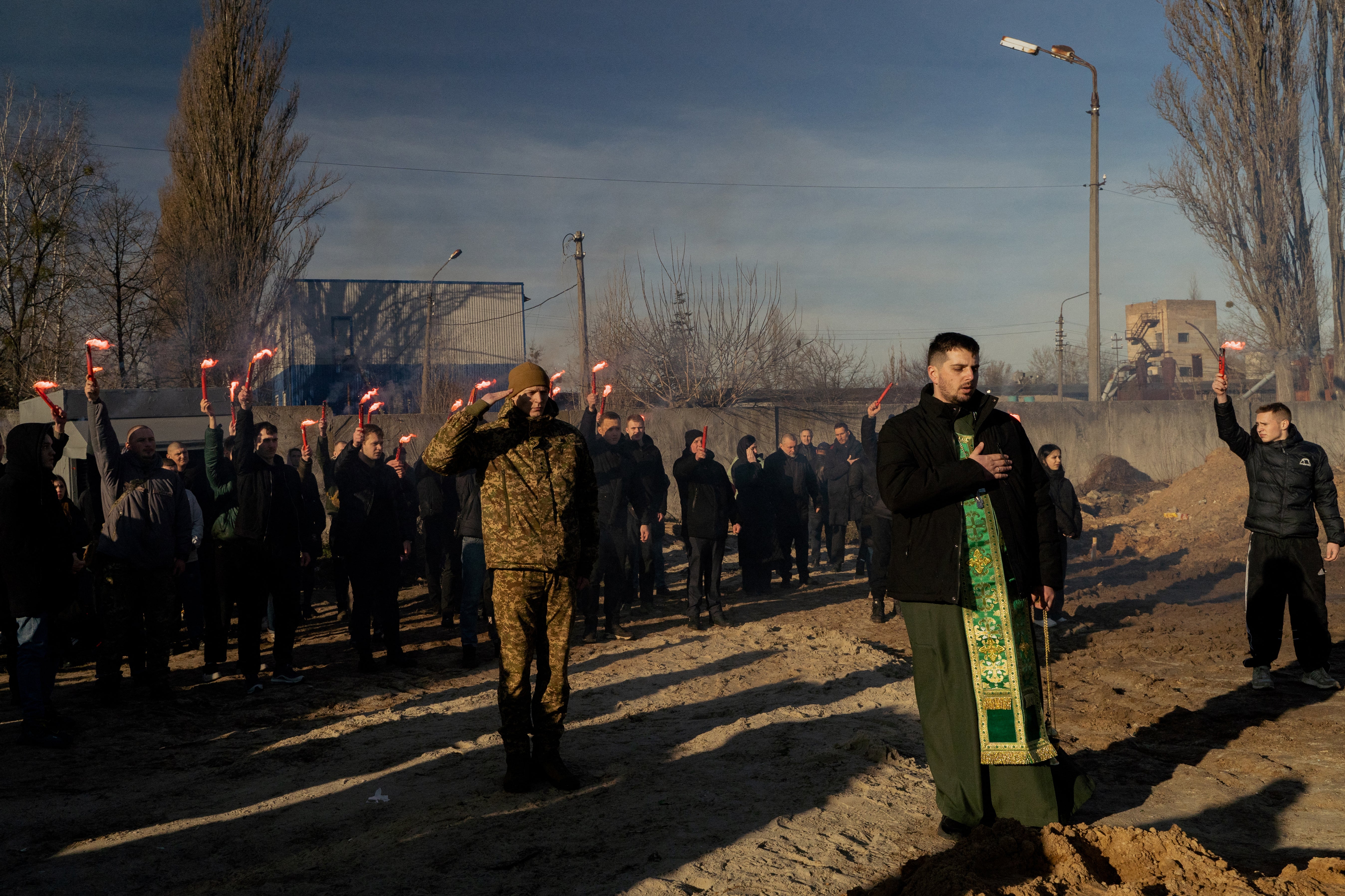 Mourners hold smoke flares during the funeral ceremony of late Ukrainian serviceman Danylo Bobrykov, callsign ‘Harvey’