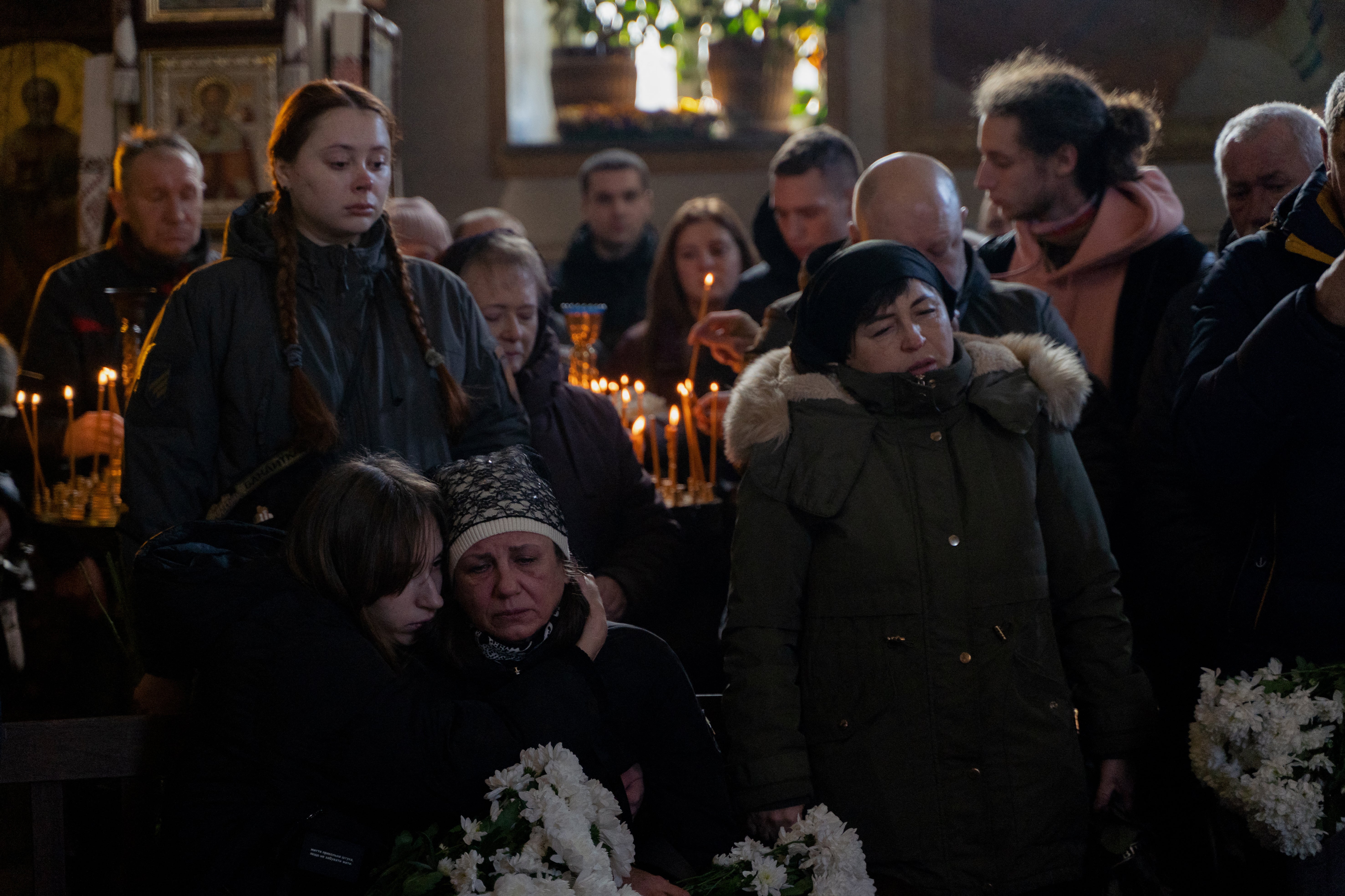 Relatives and friends gather next to the coffin of late Ukrainian serviceman Danylo Bobrykov, callsign ‘Harvey’