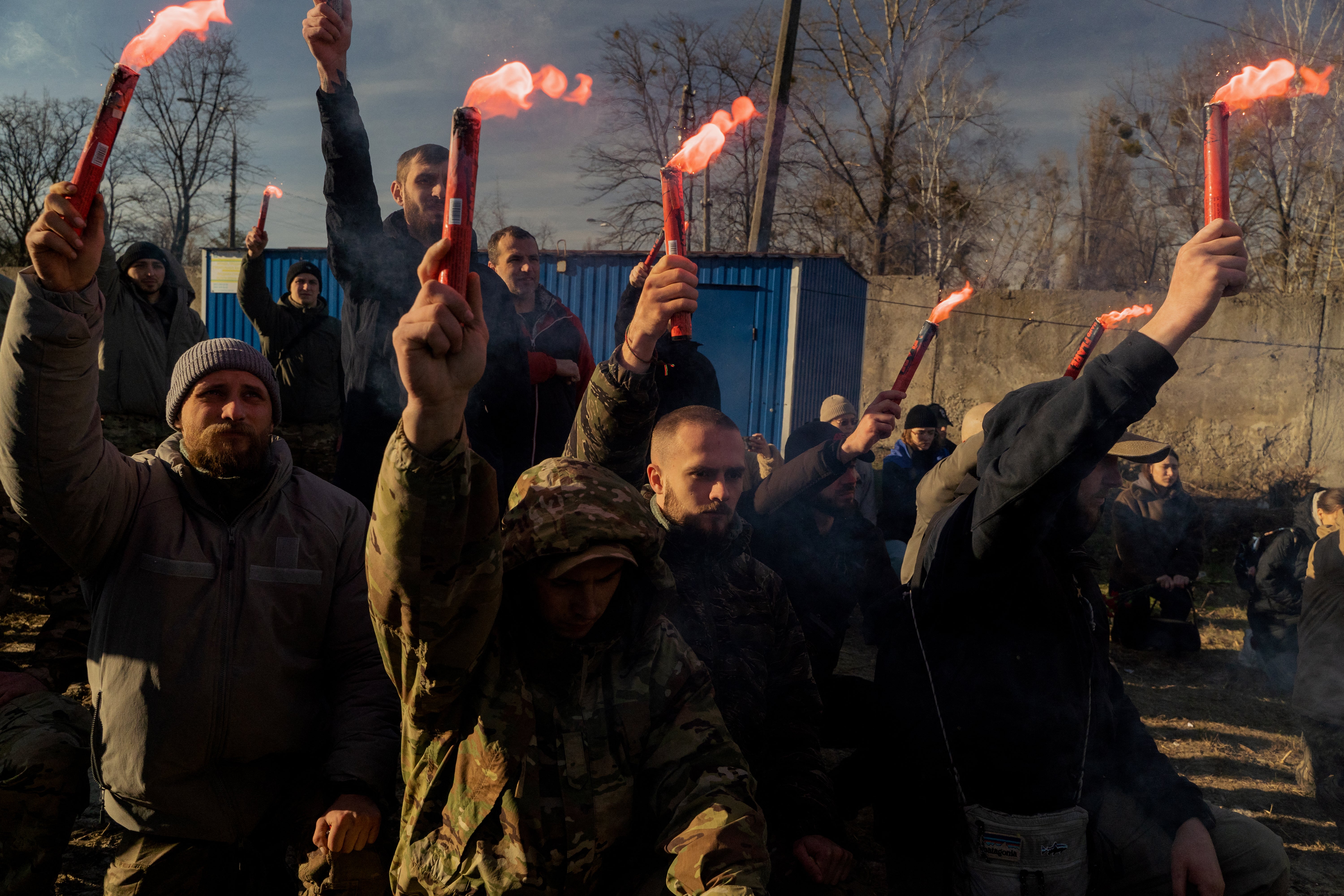 Mourners hold smoke flares during the funeral ceremony of ‘Harvey’ amid the Russian invasion of Ukraine