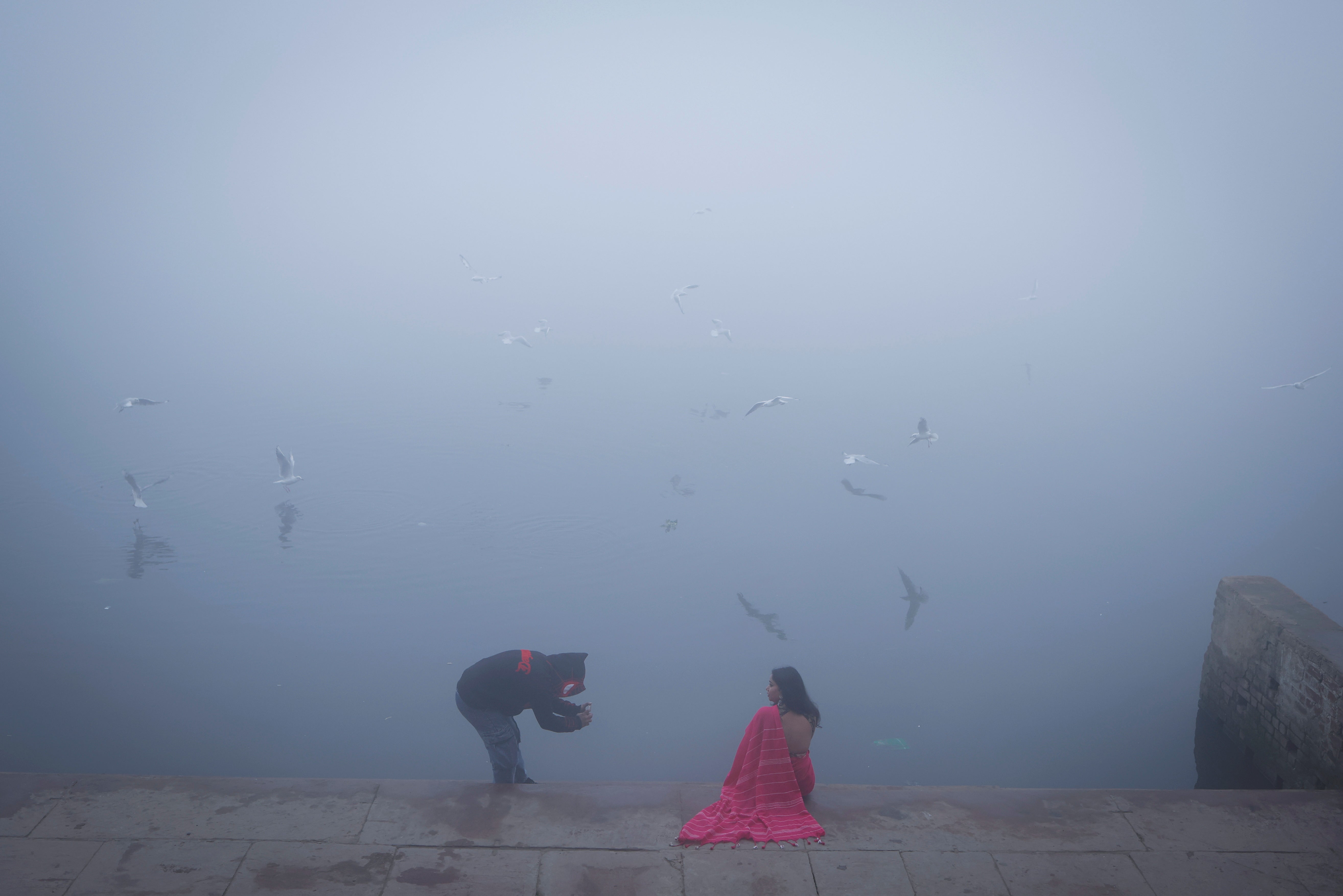 <p>A girl gets her picture clicked on the banks of the Yamuna river on a foggy winter morning in New Delhi</p>