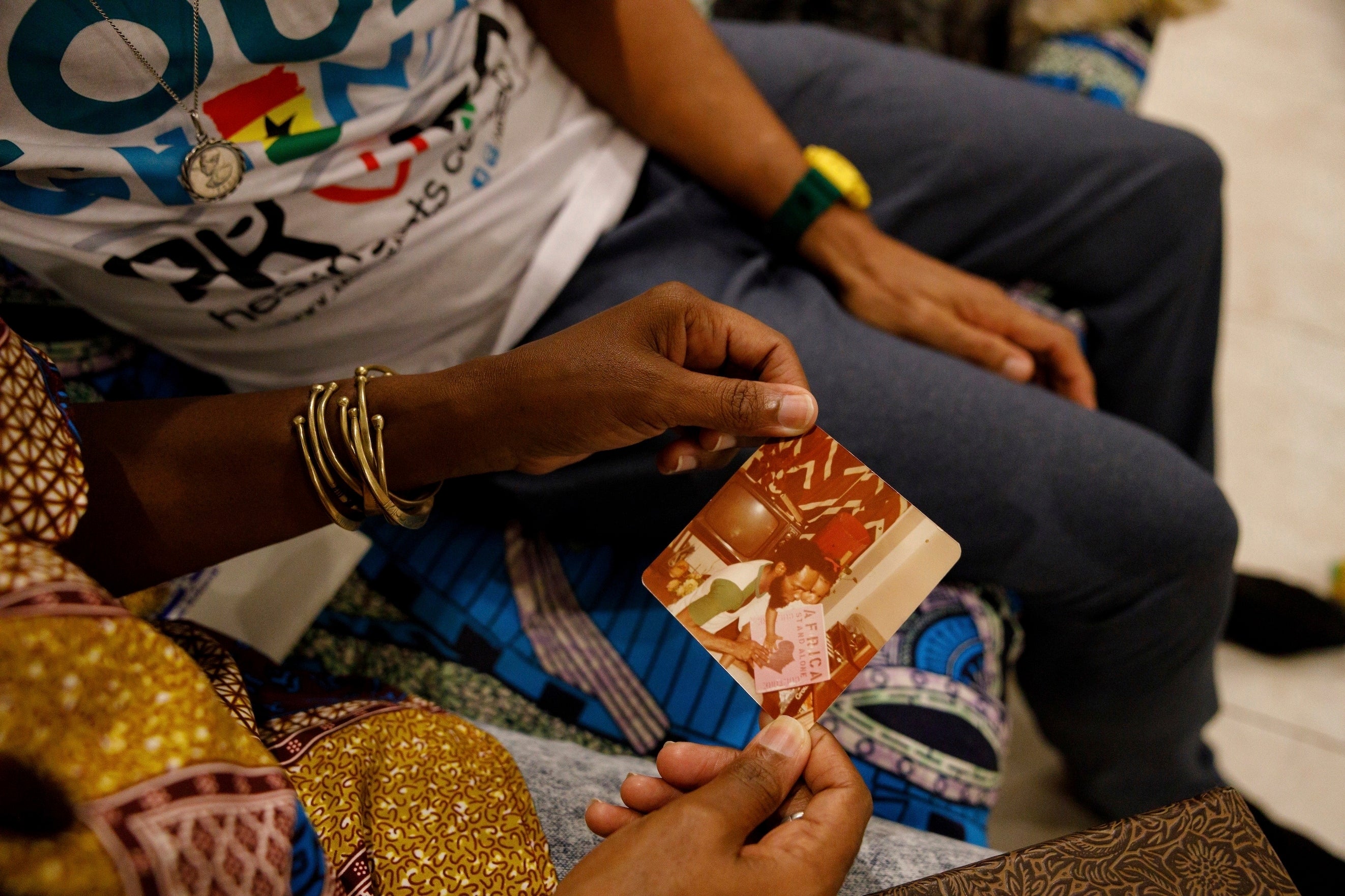 Keachia Bowers holds a photograph of her with her late father in their home in Accra, Ghana,