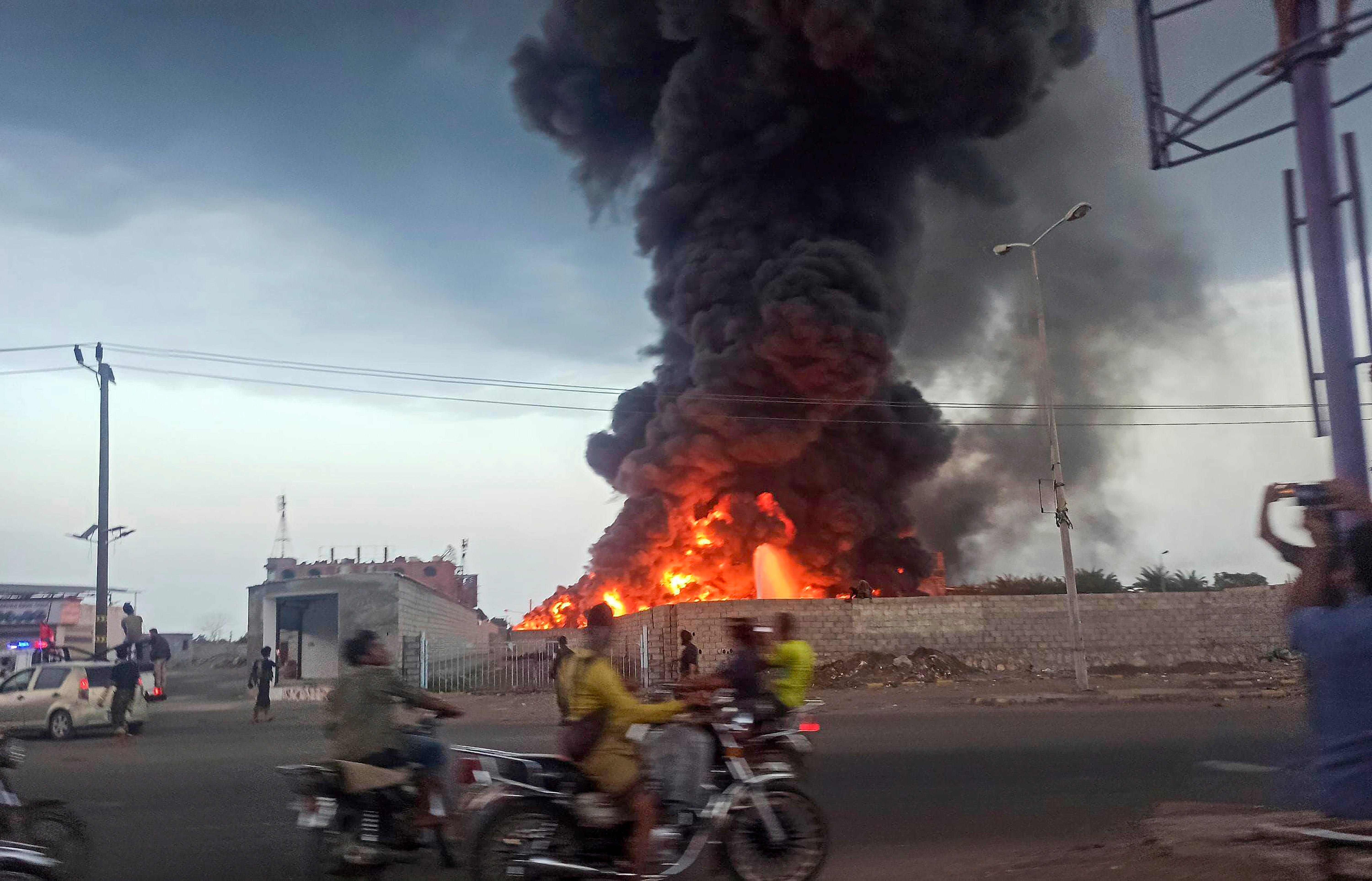 A large fire and plume of smoke is visible in the port city of Hodeida on 29 September 2024, after Israeli strikes on the Houthi-controlled city