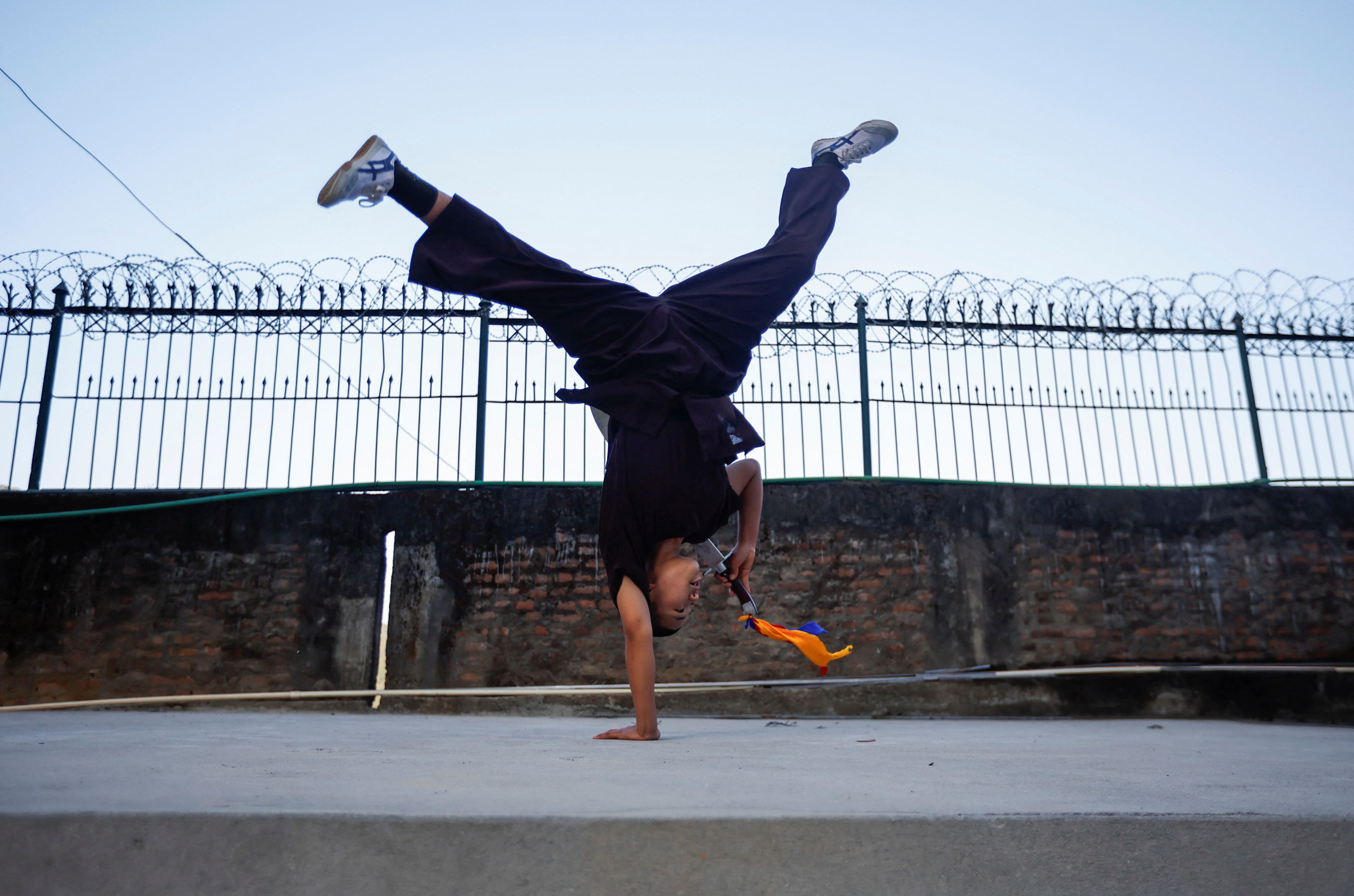 A Kung Fu nun practises before her performance during the reopening of the nunnery for the first time since the COVID-19 closure at Druk Amitabha Mountain Nunnery in Kathmandu, Nepal December 30, 2024