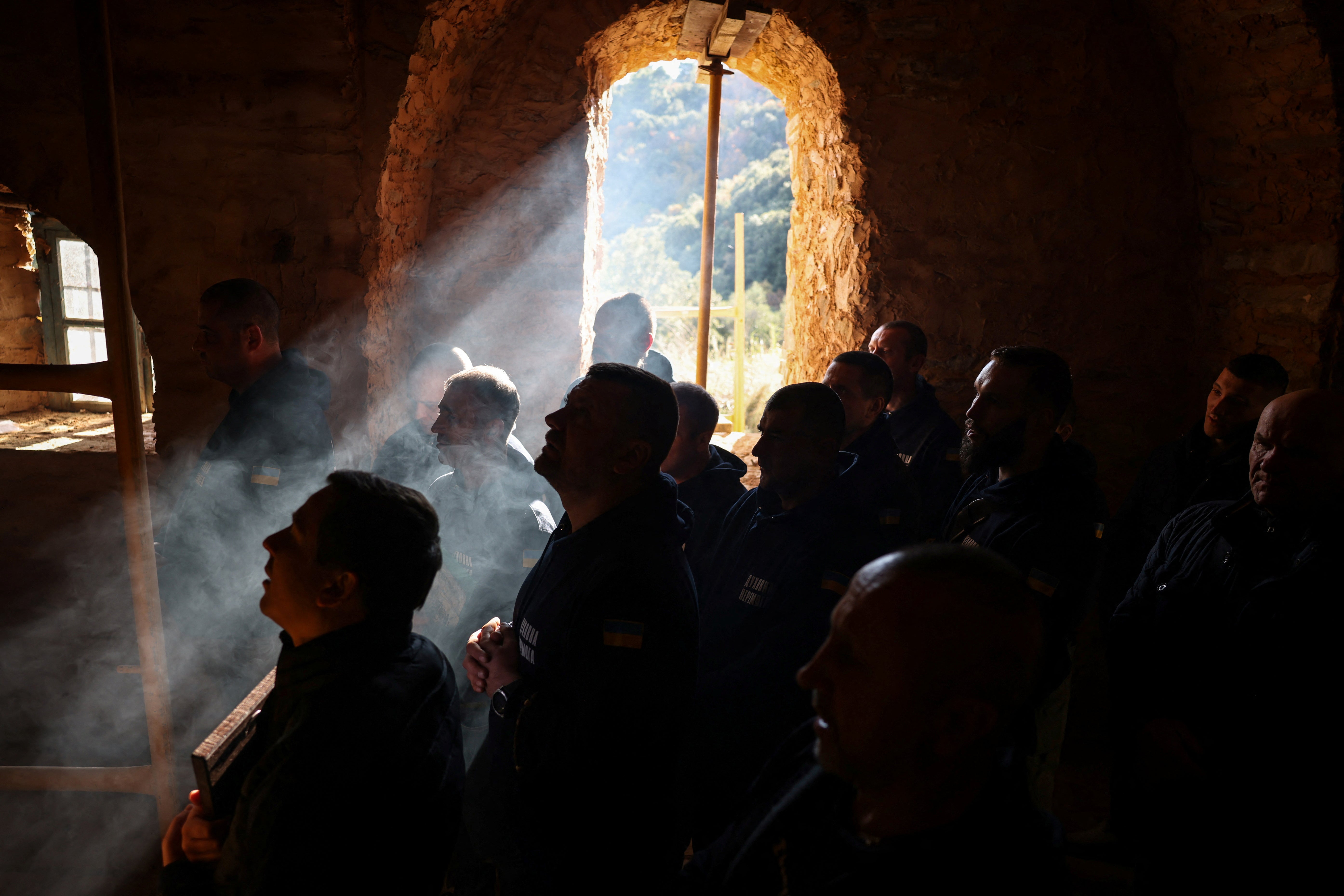 Recovering Ukrainian soldiers pray at the Holy Cell of Saints Archangels Falakrou in Mount Athos, Greece