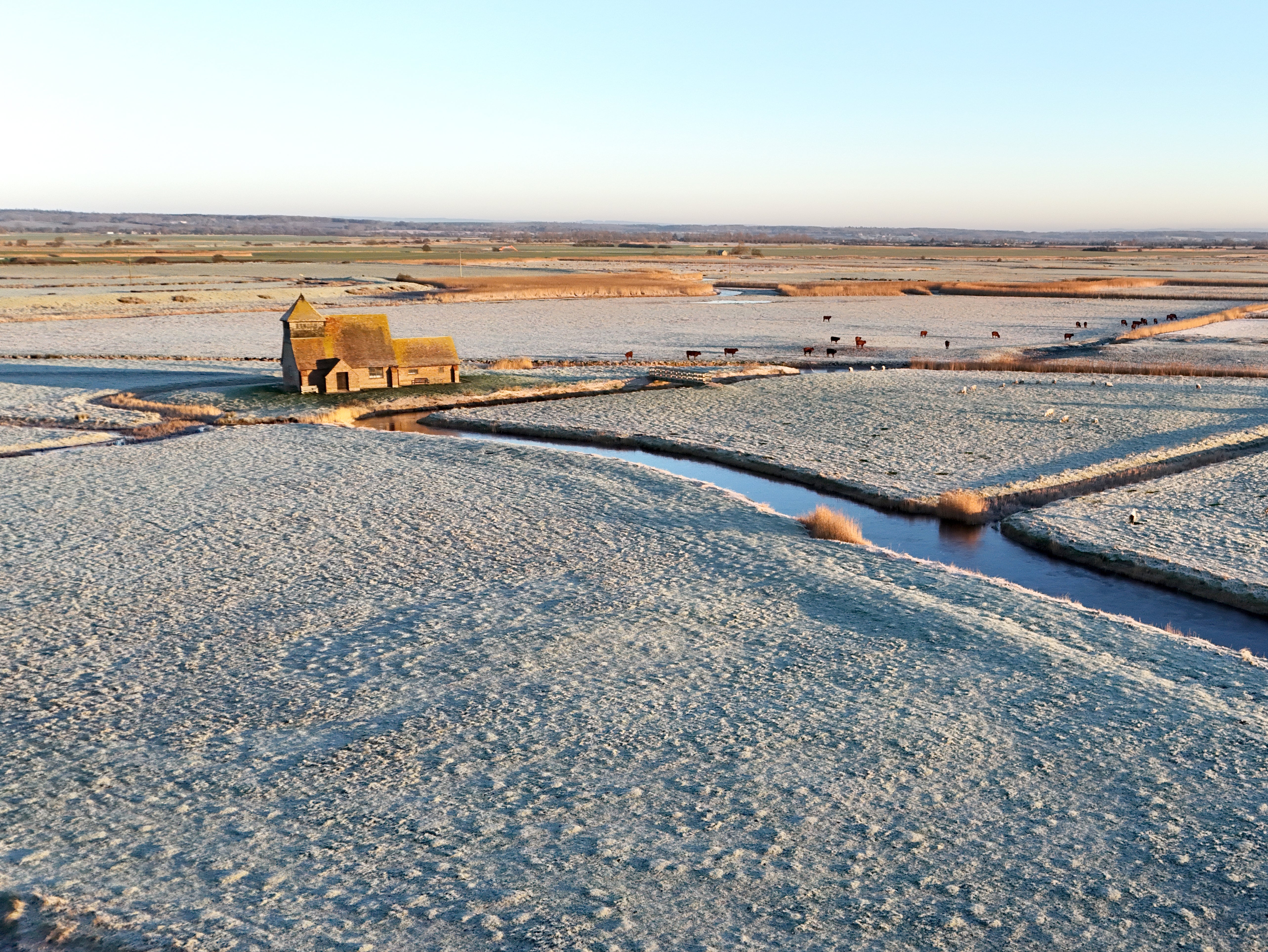 St Thomas Becket church is surrounded by frosty fields on the Romney Marsh in Kent on Friday