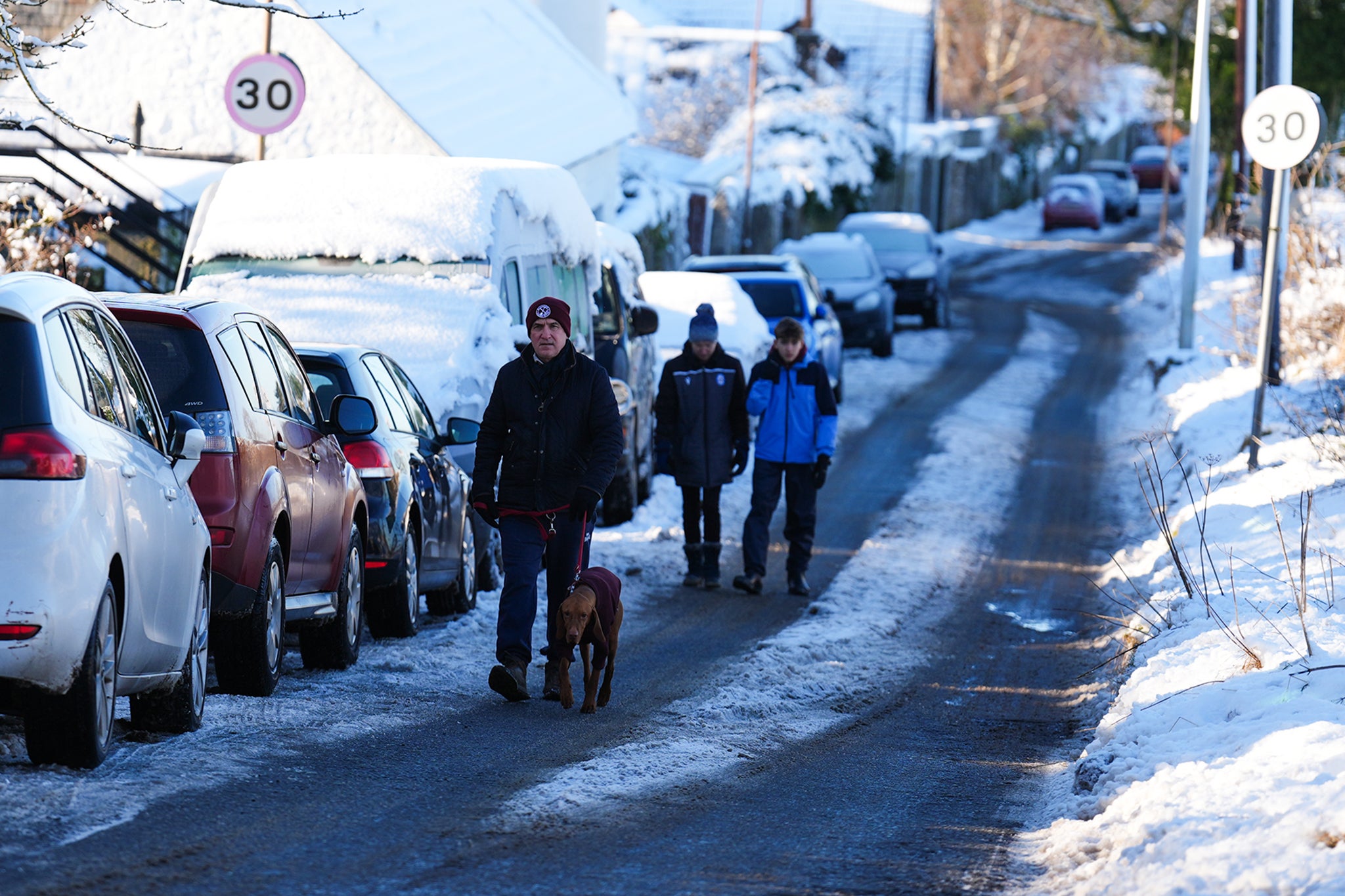 People walk through snow in Balerno, Edinburgh