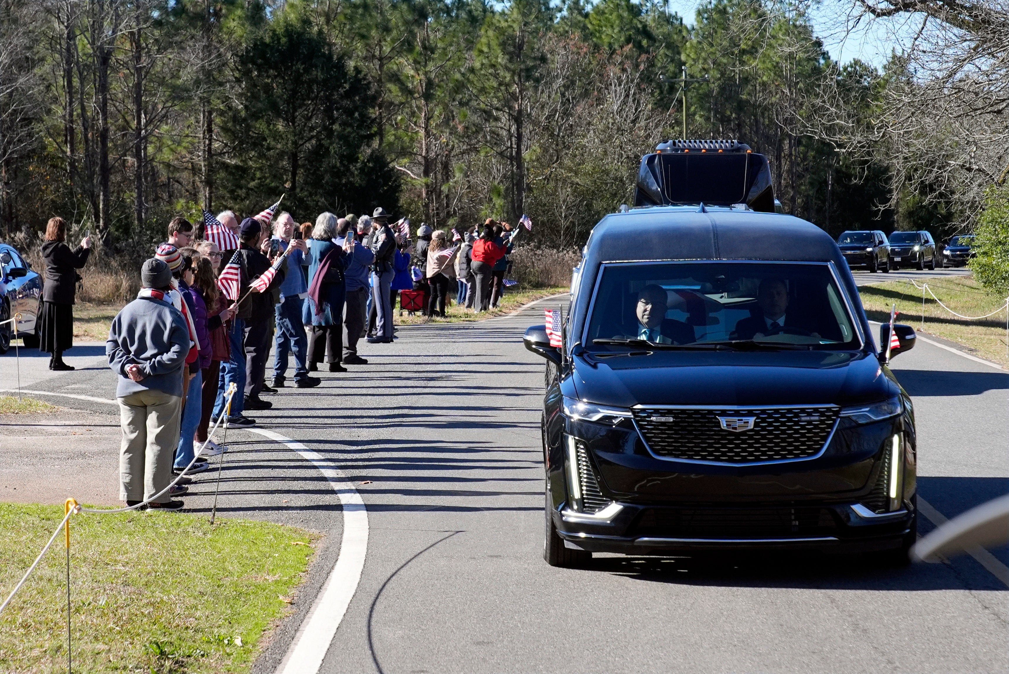 Jimmy Carter’s hearse drives through Archery, Georgia on Saturday afternoon