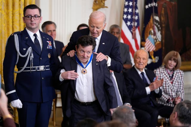 <p>President Joe Biden, right, presents the Presidential Medal of Freedom, the Nation's highest civilian honor, to Michael J. Fox, center, in the East Room of the White House, Saturday, Jan. 4, 2025, in Washington</p>