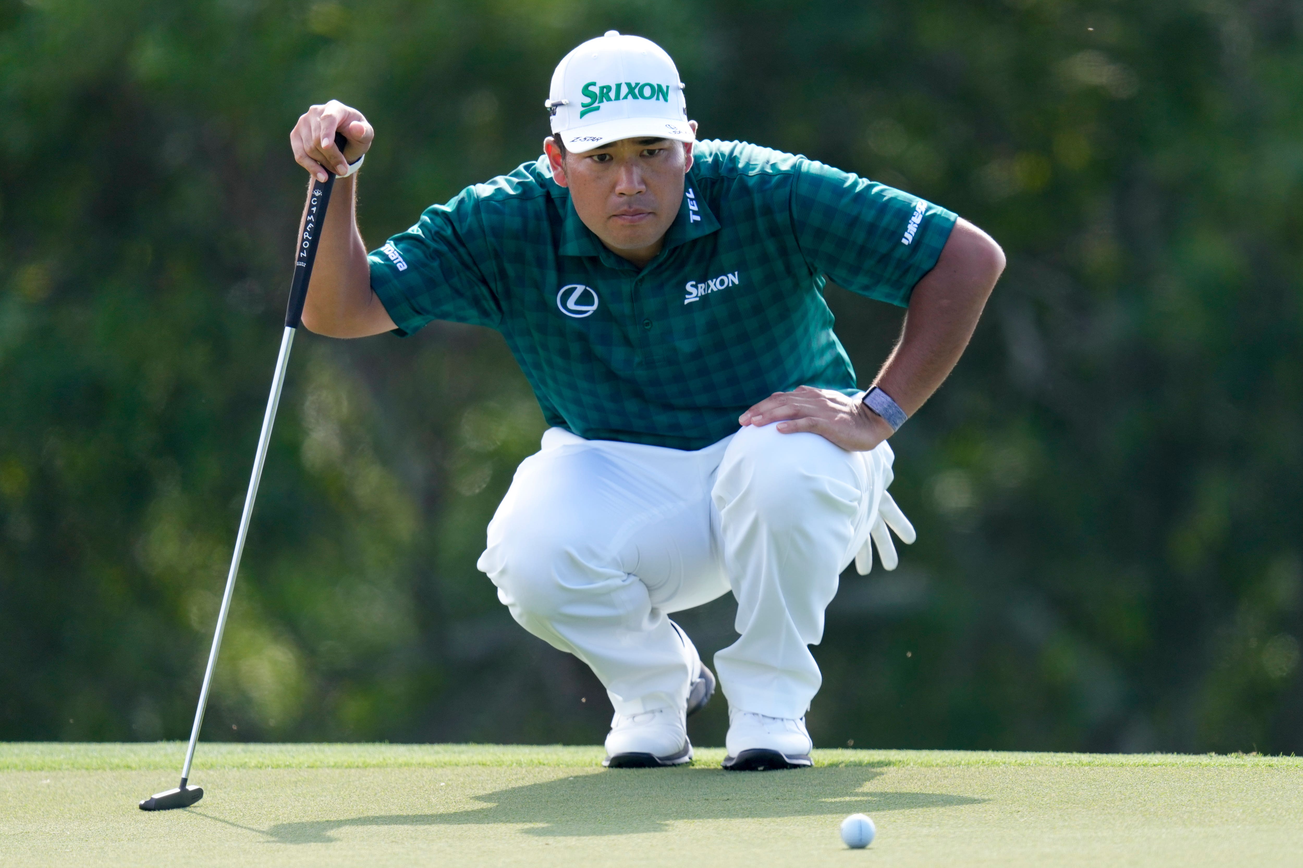 Hideki Matsuyama, of Japan, lines up his putt on the 17th green during the third round of The Sentry on Saturday (Matt York/AP)