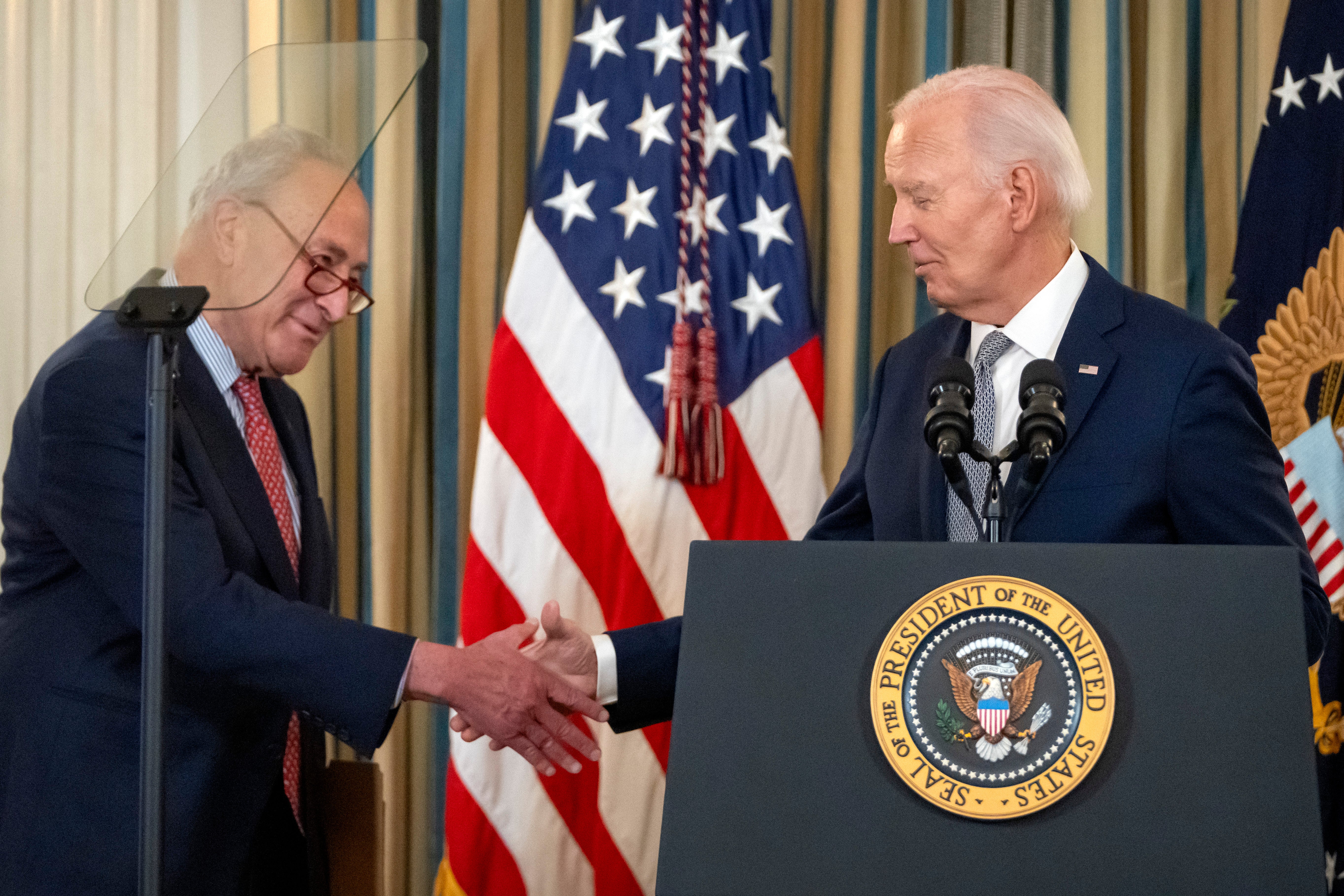 Chuck Schumer shakes hands with Joe Biden during an event at the White House this week. The senator insists his party did not mislead the public