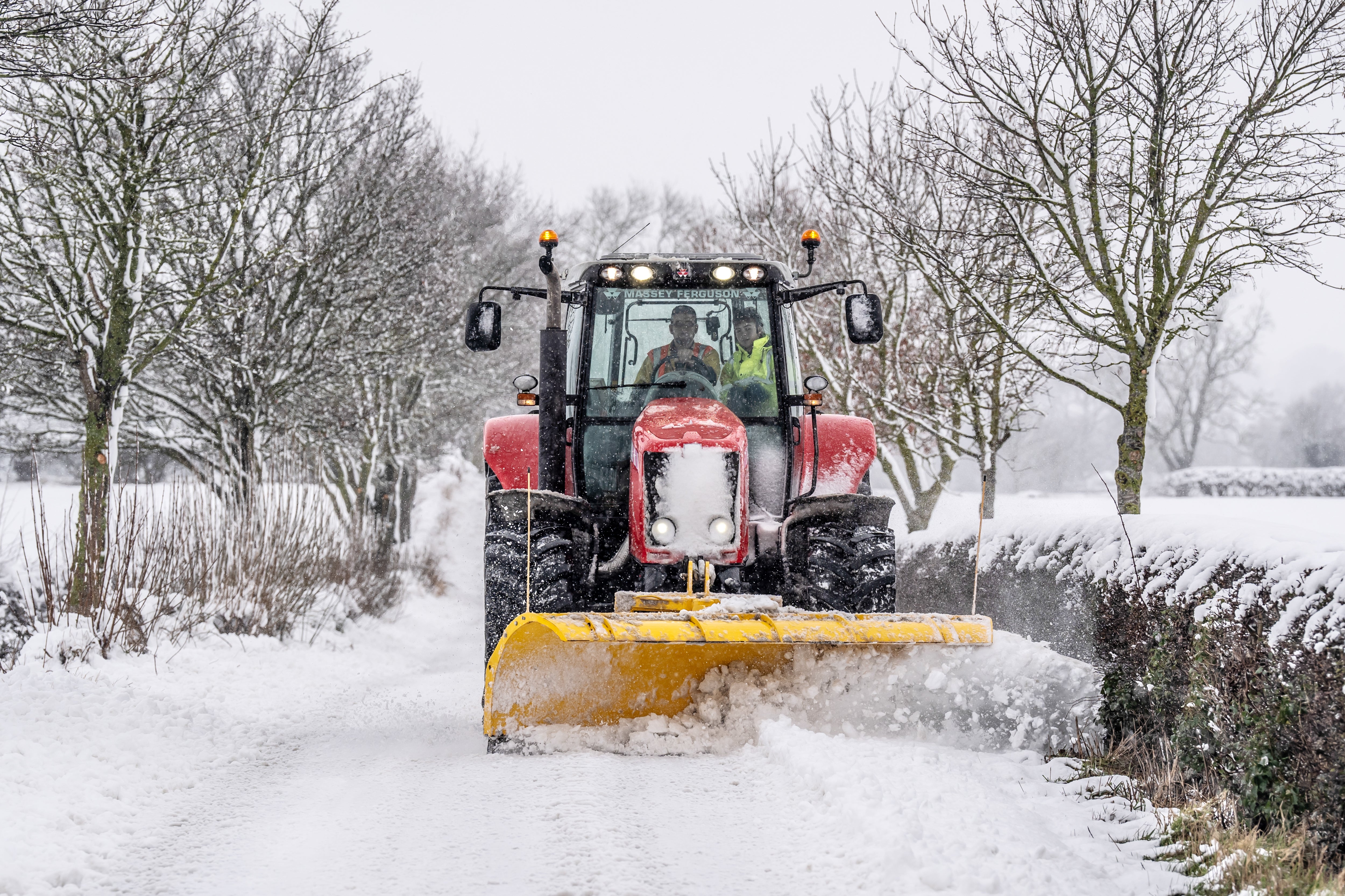 A tractor clears snow from a road in Harrogate, North Yorkshire