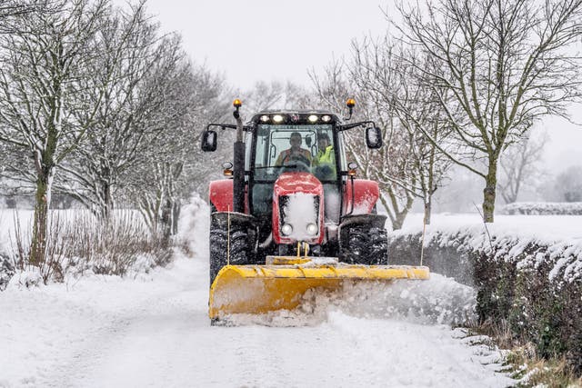 <p>A tractor clears snow from a road in Harrogate, North Yorkshire</p>