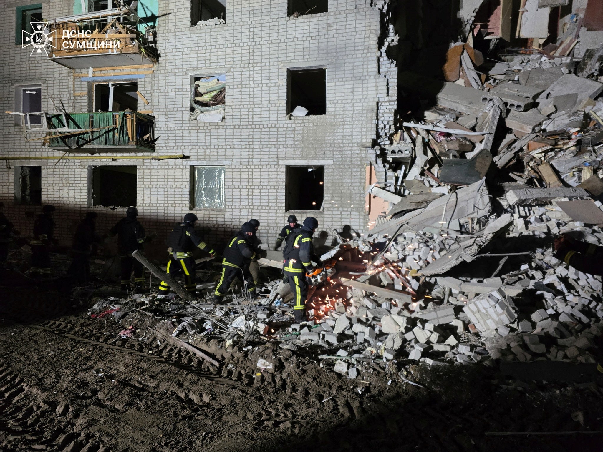 Rescuers work at the site of a residential building hit by a Russian air strike in the village of Svesa, amid Russia's attack on Ukraine, in Sumy region, Ukraine January 4, 2025