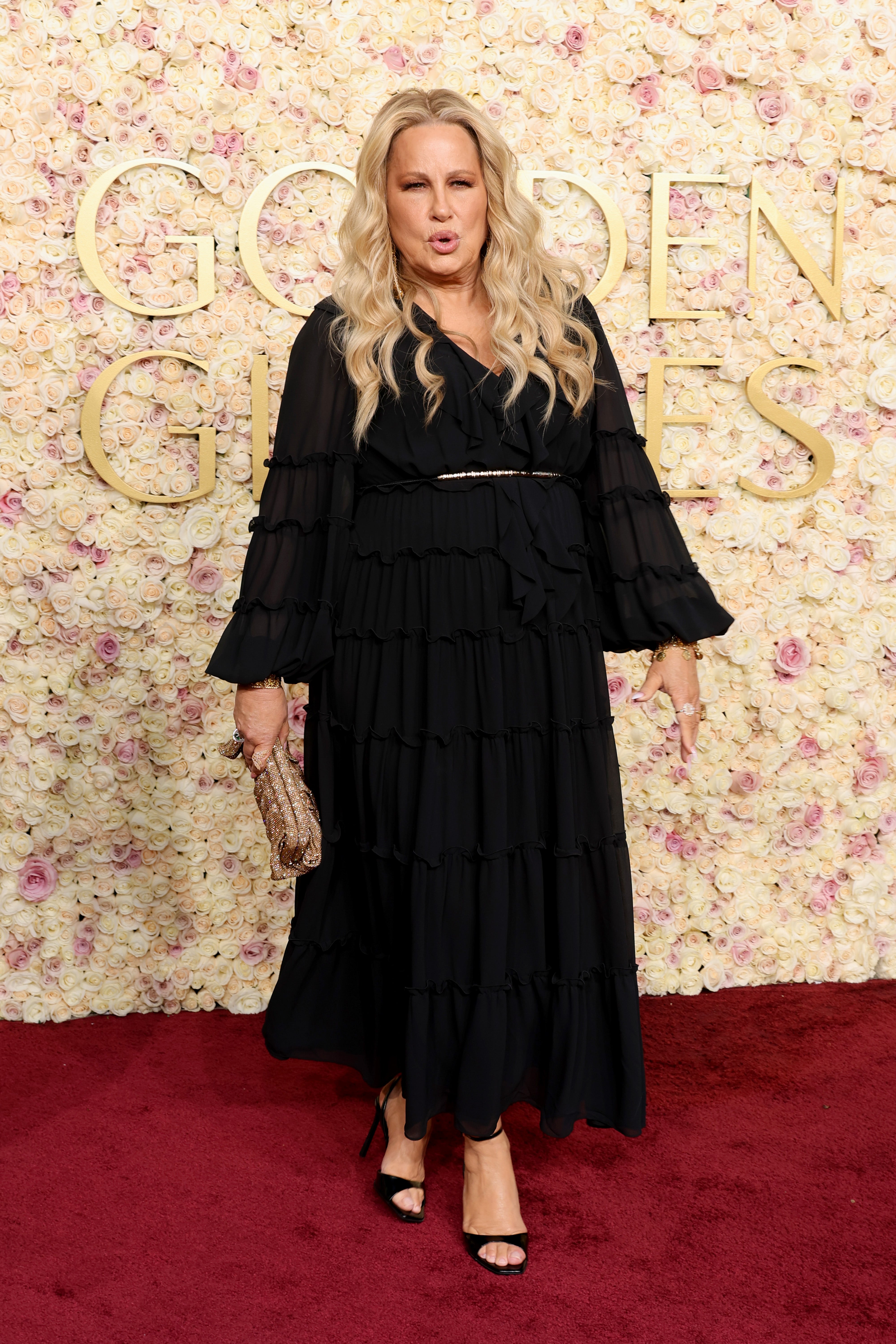 Jennifer Coolidge wore an all-black dress with a white belt at the Golden Globes.