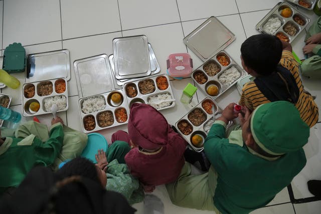 <p>Students tuck into meals provided through President Prabowo Subianto's ambitious free meal programme</p>