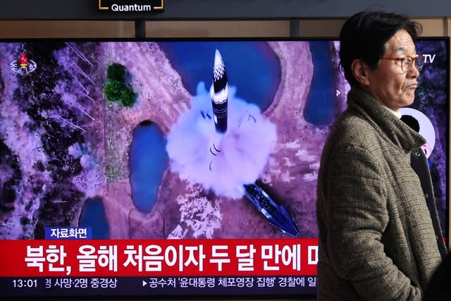 <p>A man walks past a TV broadcasting a news report on North Korea firing a ballistic missile out to sea off its east coast, in Seoul, South Korea</p>