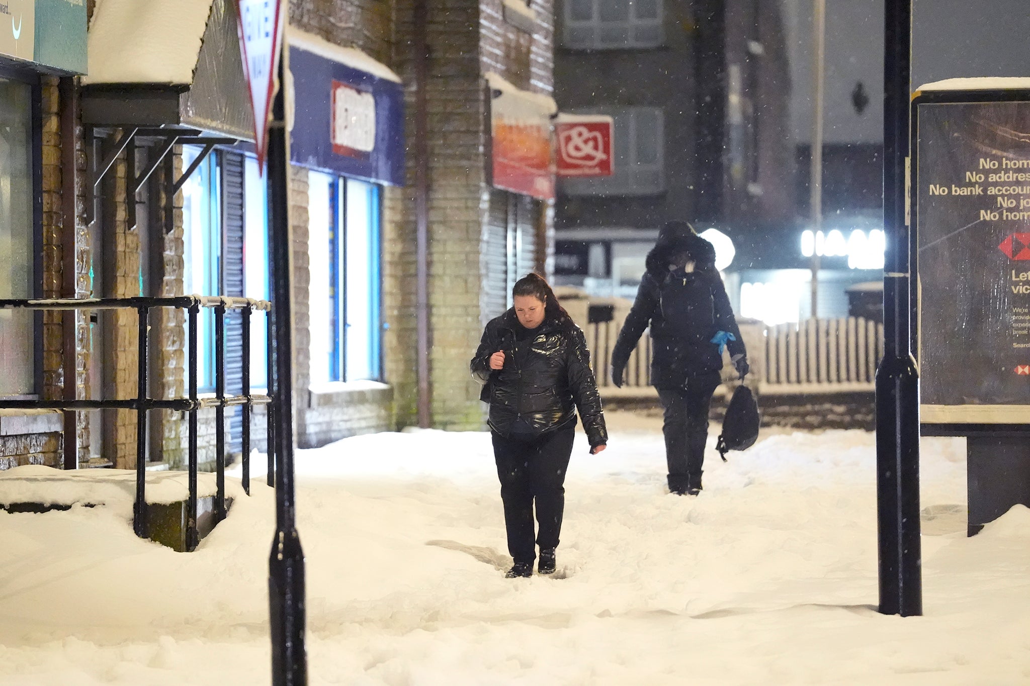 A person walks through snow in Bradford