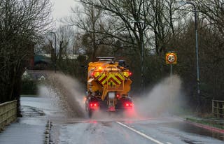 A spreader vehicle drives through standing water in Upton upon Severn, Worcestershire