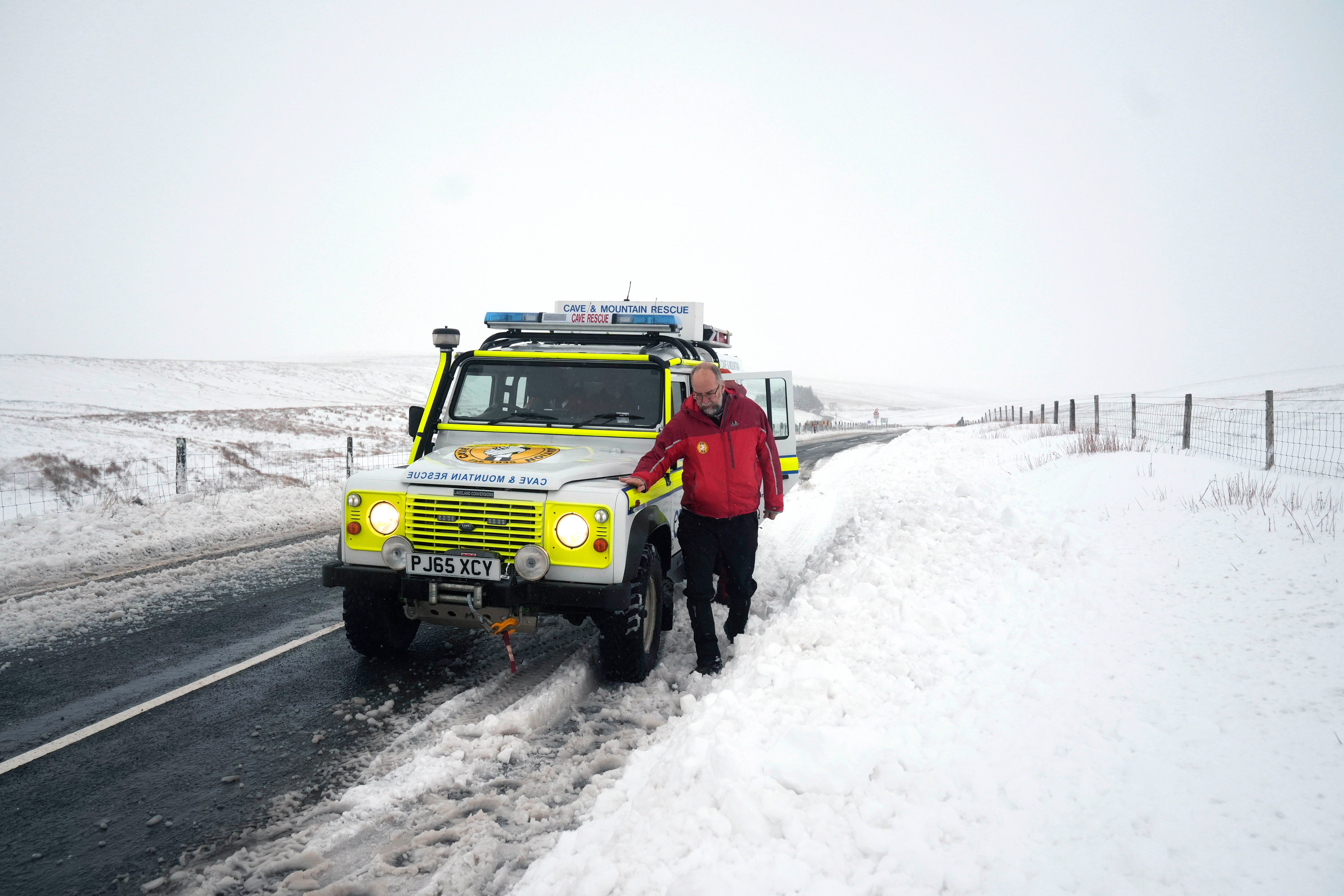 A member of a mountain rescue team after helping to clear cars from a snow drift near Ribblehead in North Yorkshire