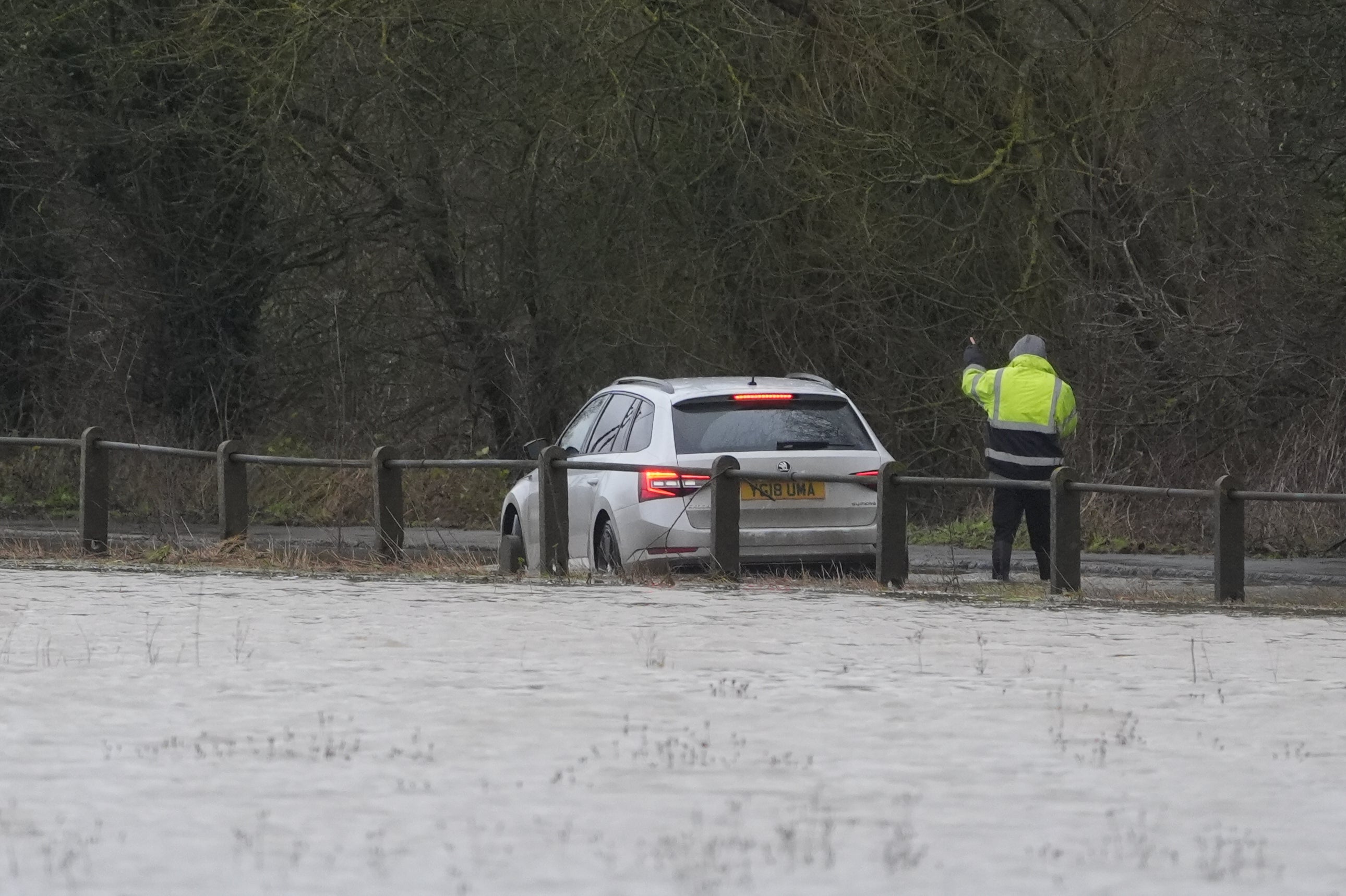 A vehicle is driven through floodwater in Yalding, Kent