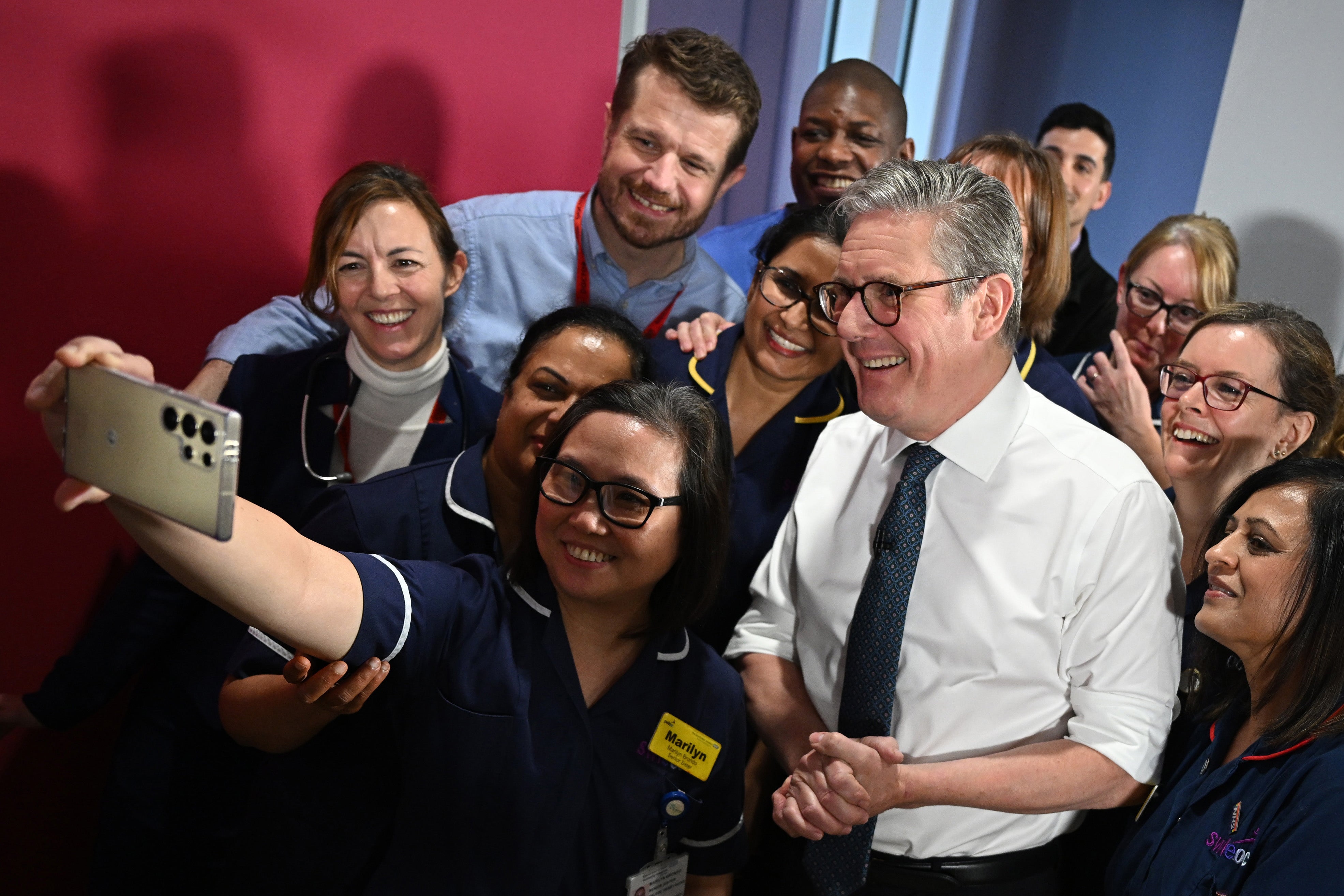 Prime Minister Sir Keir Starmer takes a selfie with members of NHS staff at the end of a visit to the Elective Orthopaedic Centre in Epsom (Leon Neal/PA)