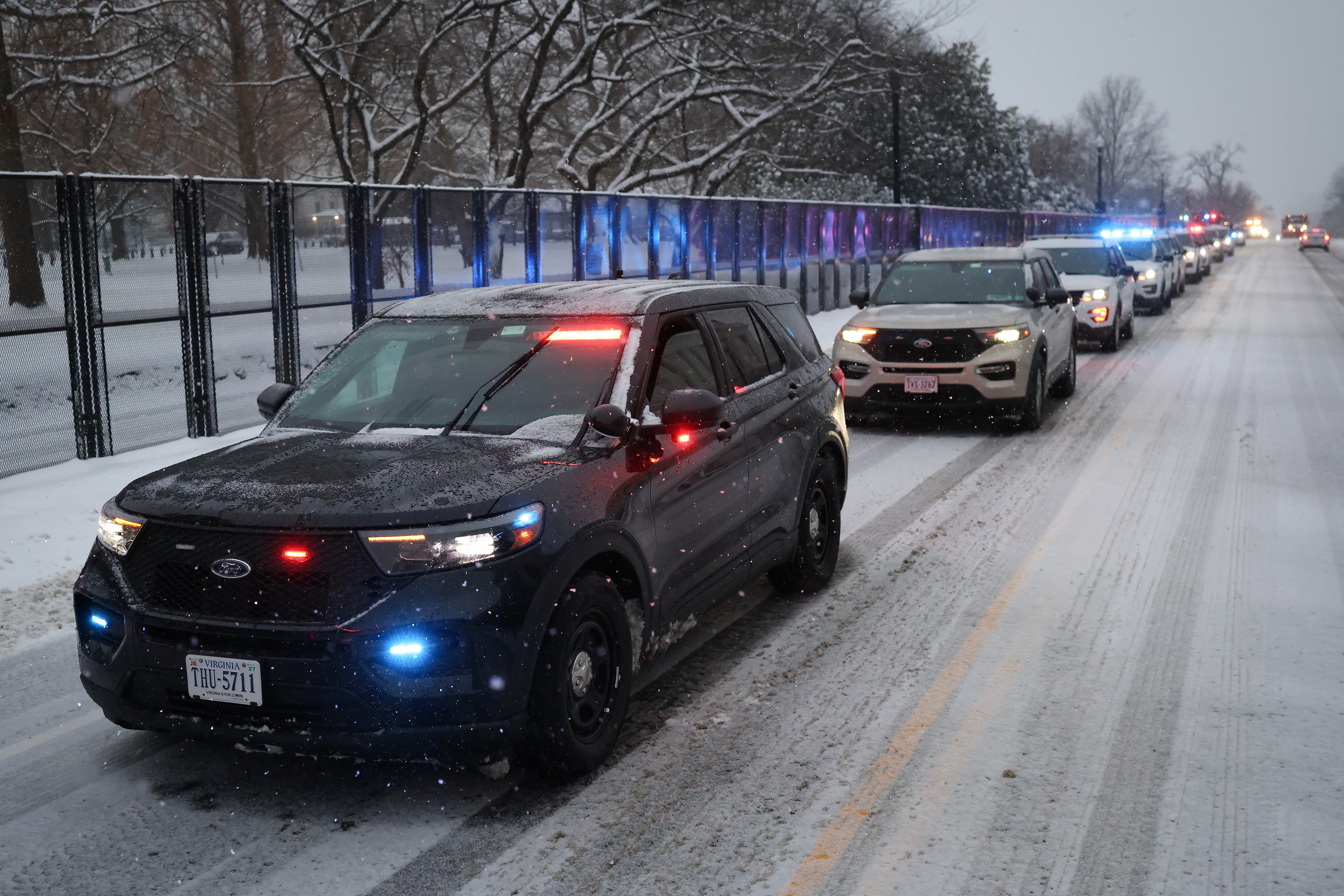 Law enforcement vehicles line the perimeter of the U.S. Capitol on Constitution Avenue