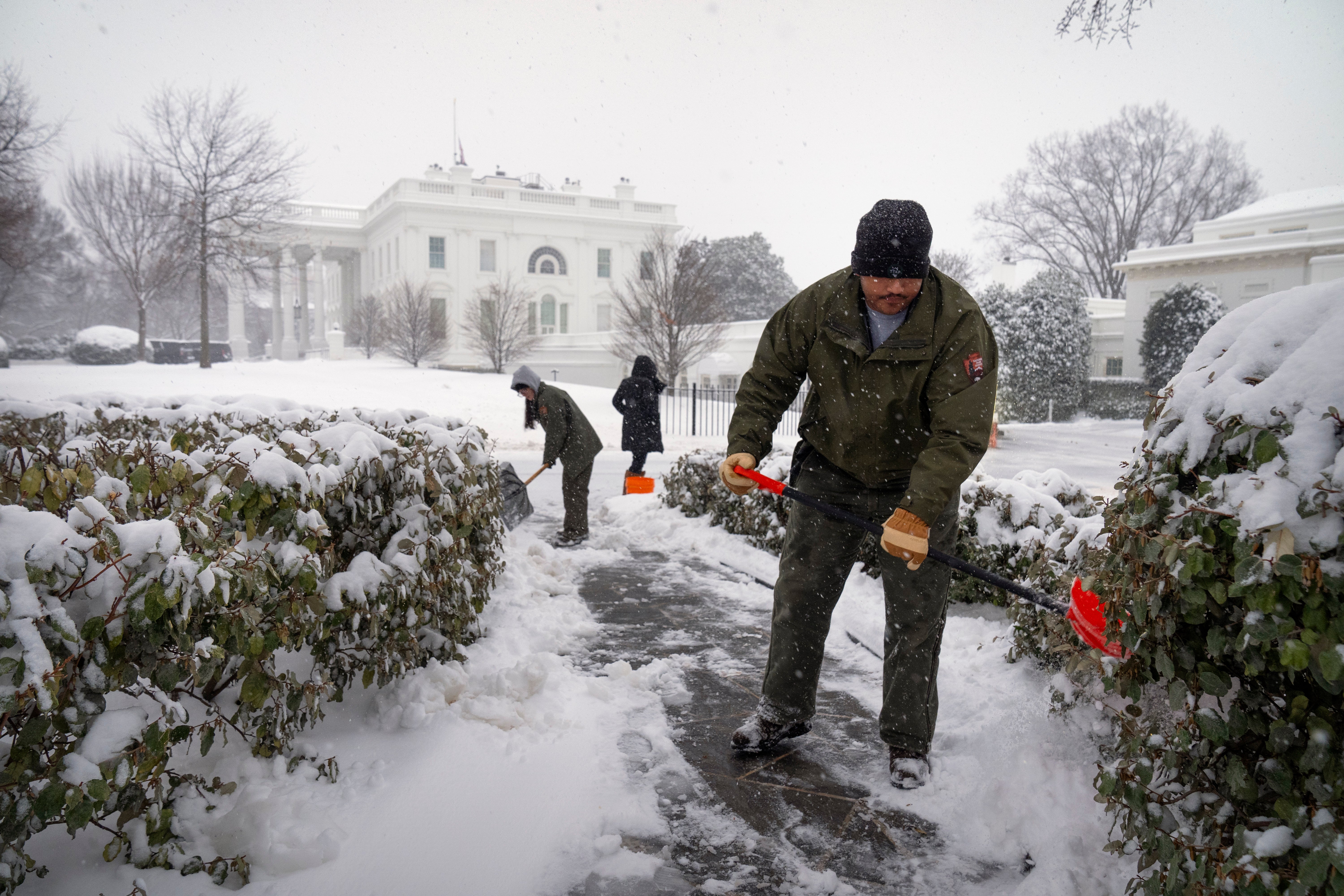 National Park Service workers shovel a pathway