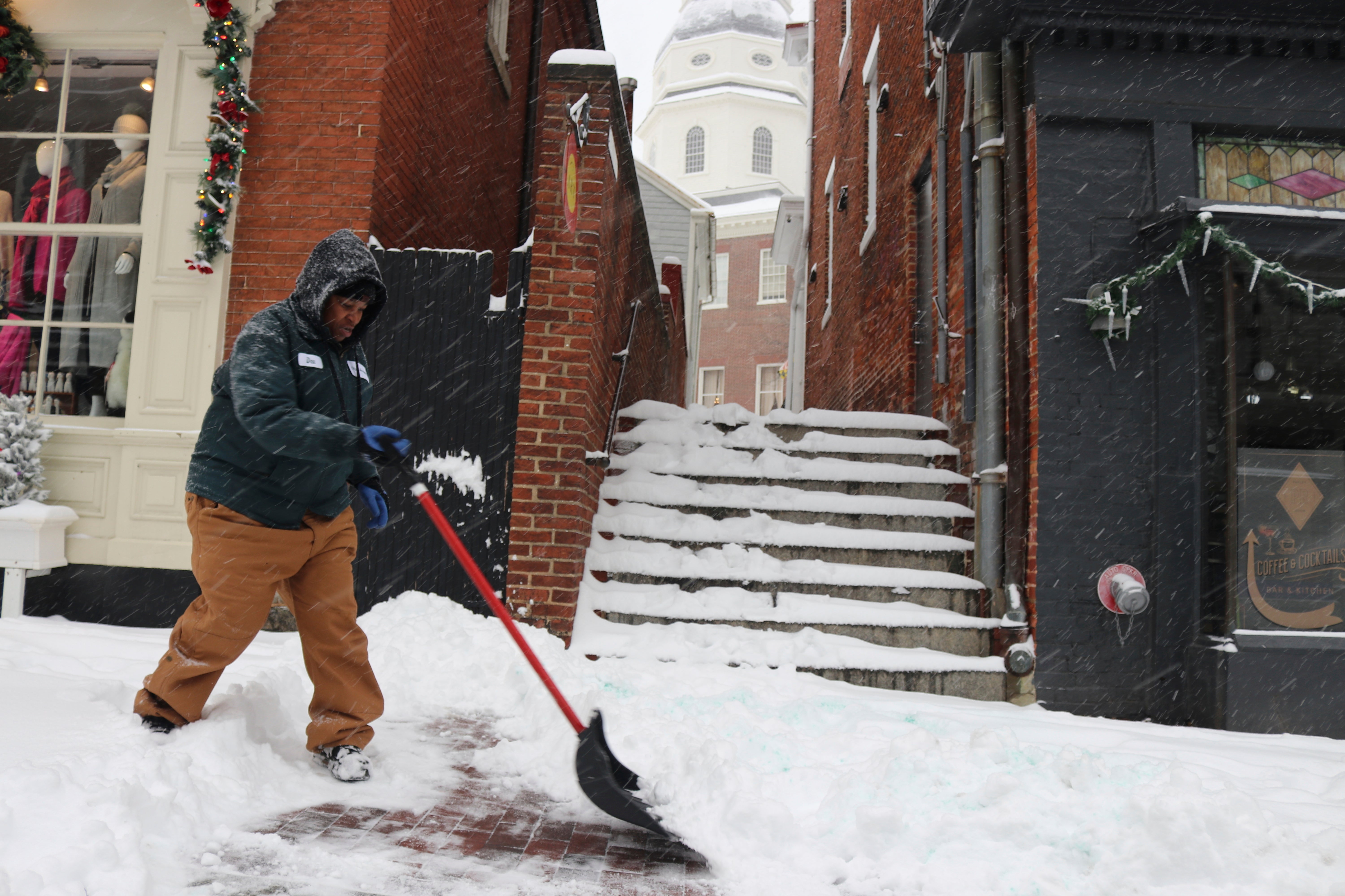 Desheria Franklin, who works for the city of Annapolis, shovels snow on Monday in Annapolis, Maryland. Maryland schools were closed due to the inclement weather conditions